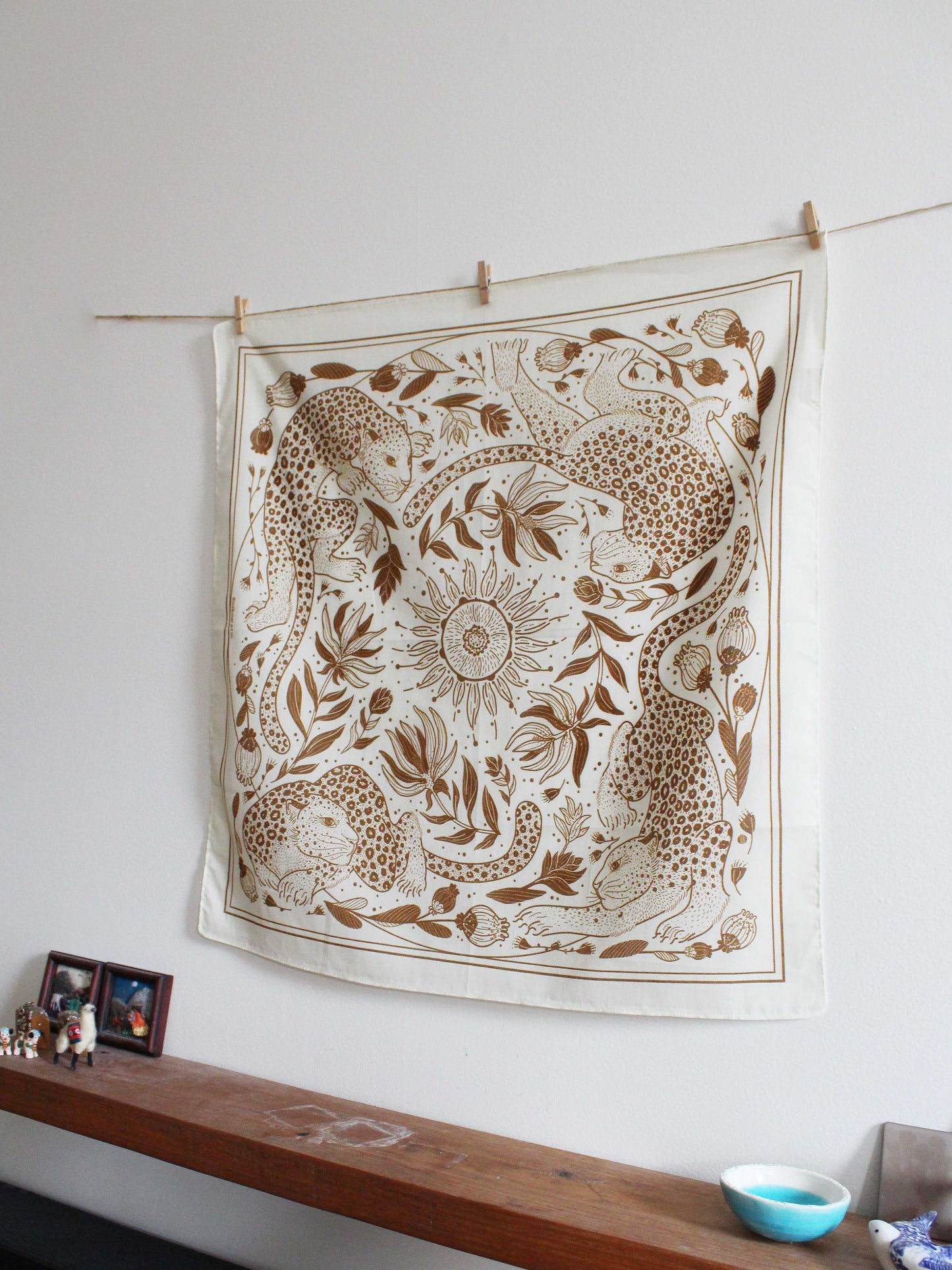 Off-white bandana scarf with illustrated leopard and sun design, perfect as a wall hanging or accessory.