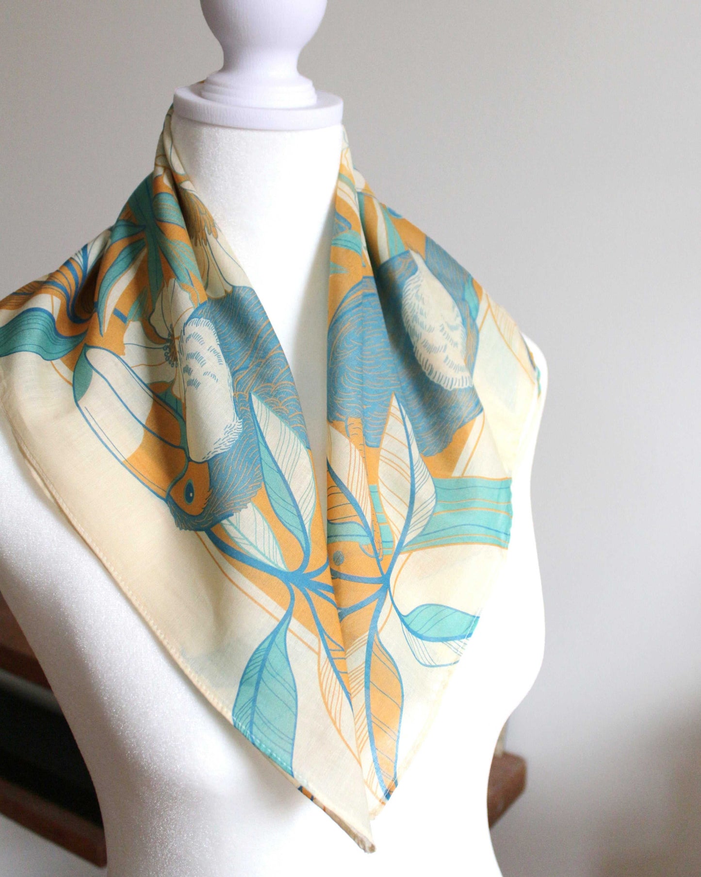 Toucan in Floral Jungle Bandana Scarf showcasing vibrant colors and tropical design on a mannequin.