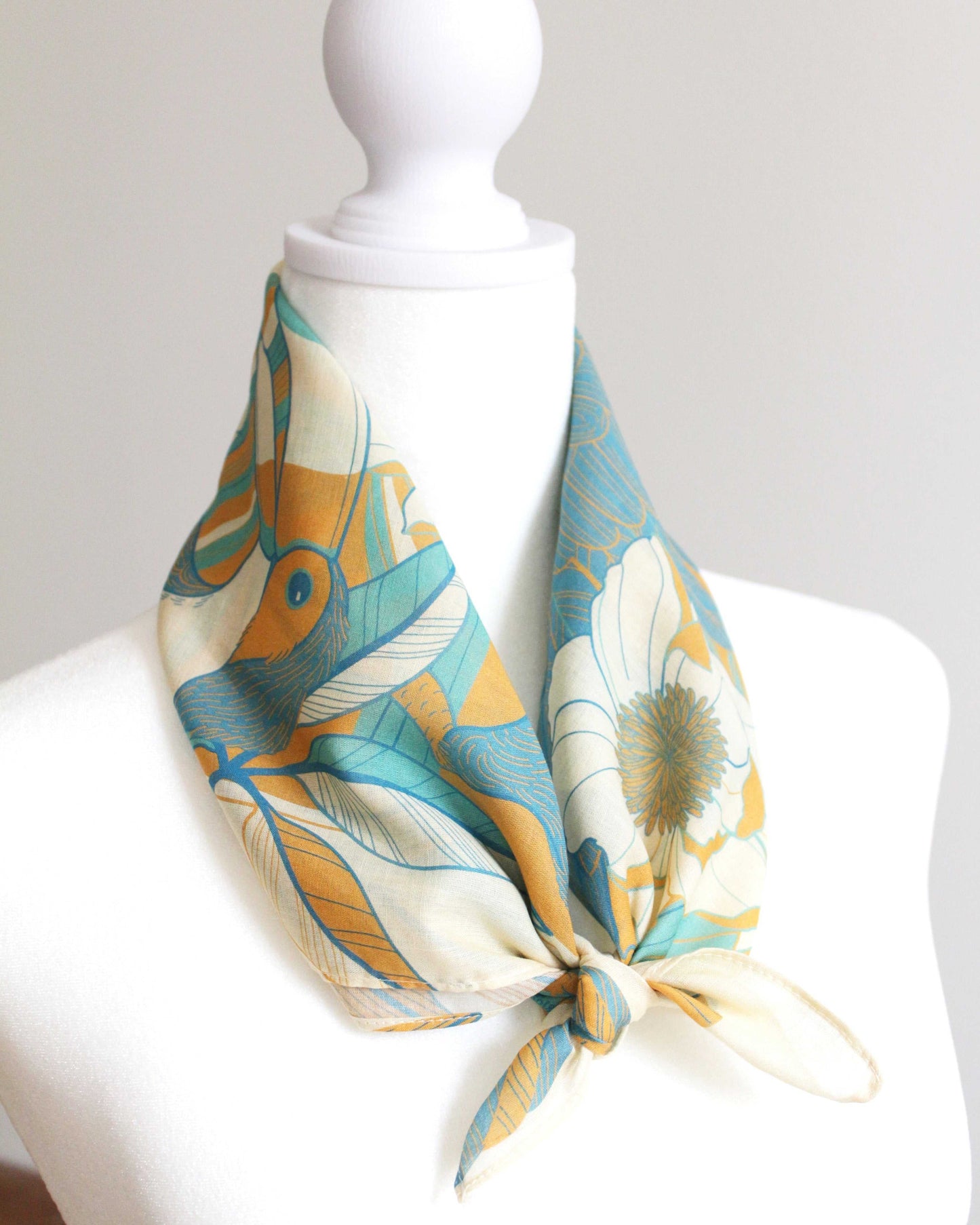 Toucan in Floral Jungle Bandana Scarf on mannequin, showcasing vibrant colors and tropical design details. Perfect summer accessory.