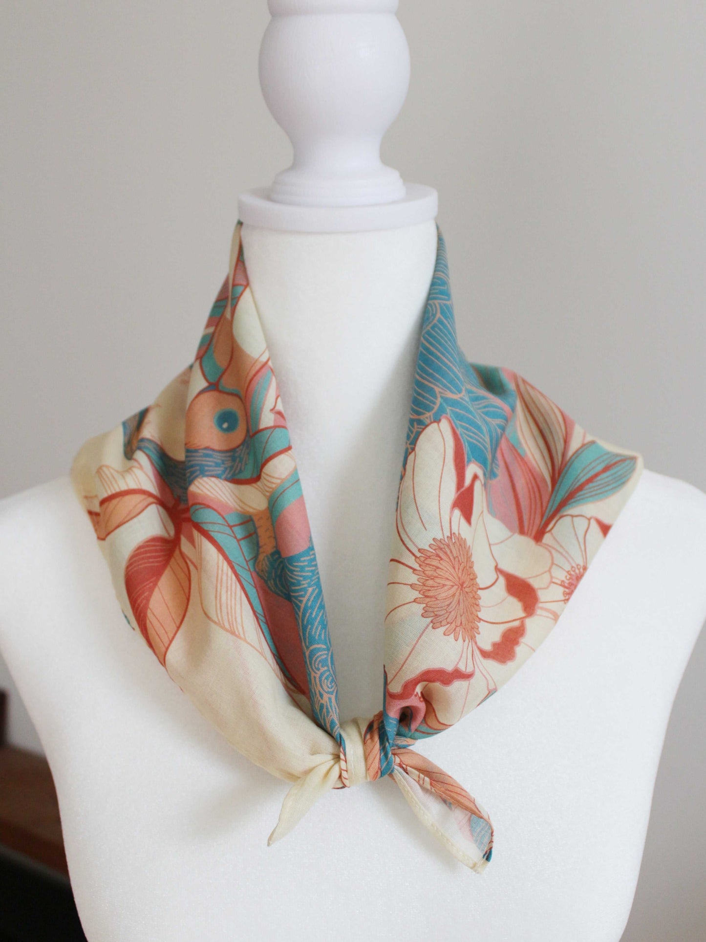Toucan in the Floral Jungle bandana scarf in soft cotton, styled on a mannequin with vibrant floral design.