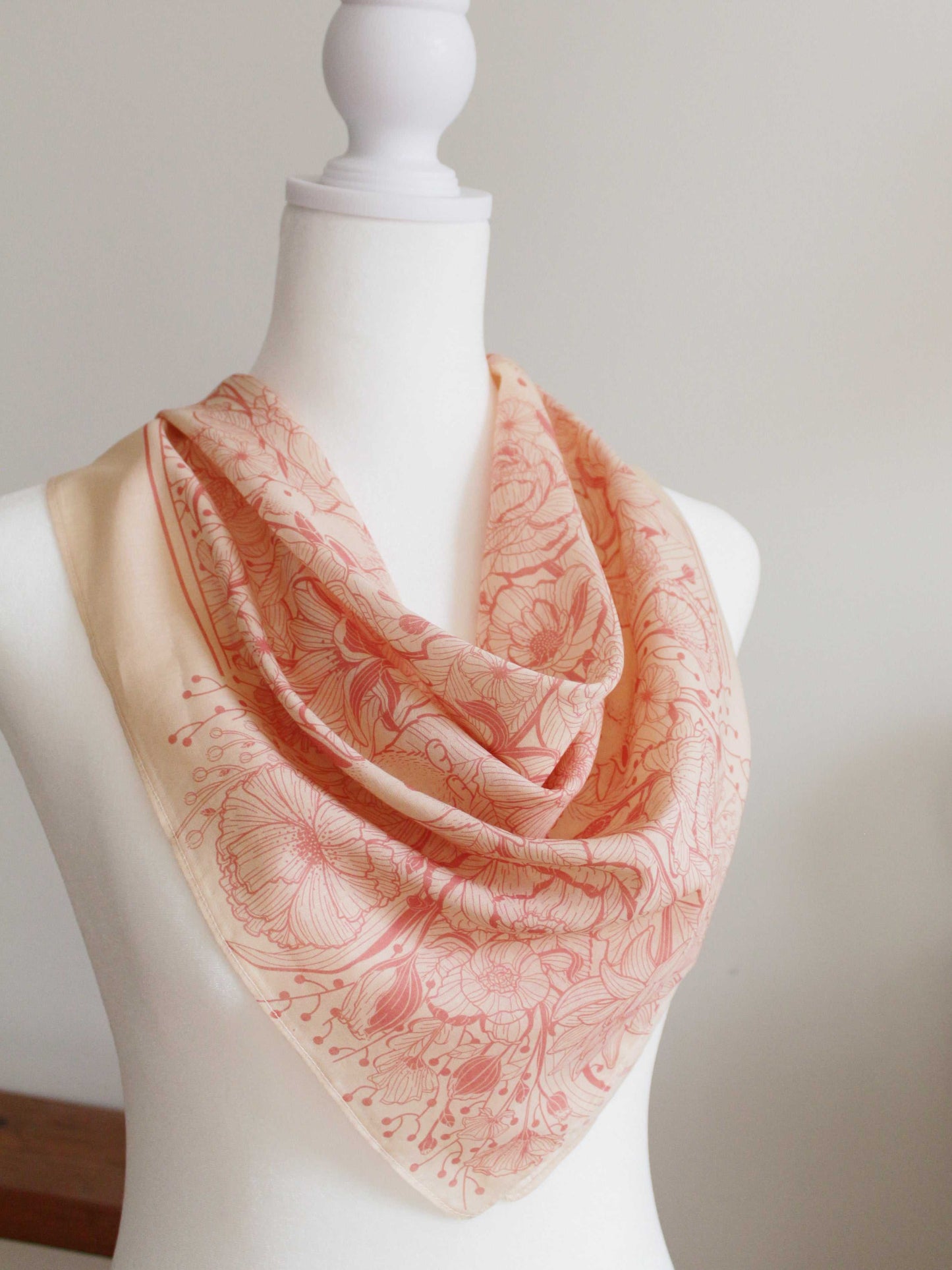 Bunny in the Floral Breeze pastel pink bandana scarf displayed on a mannequin, featuring floral and rabbit artwork.