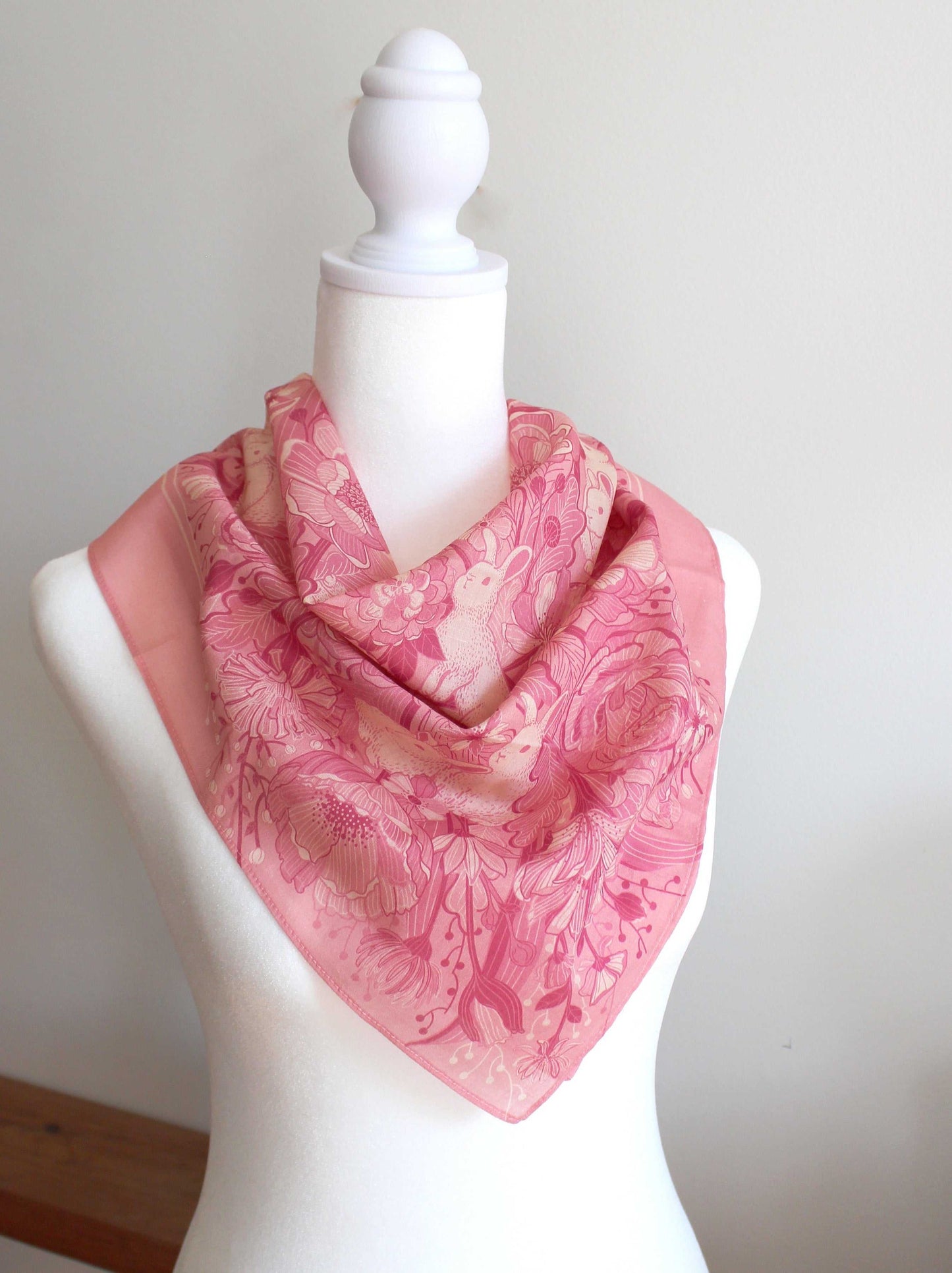 Bunny in the Floral Breeze Bandana Scarf (Pink) displayed on a mannequin, featuring floral and rabbit designs.