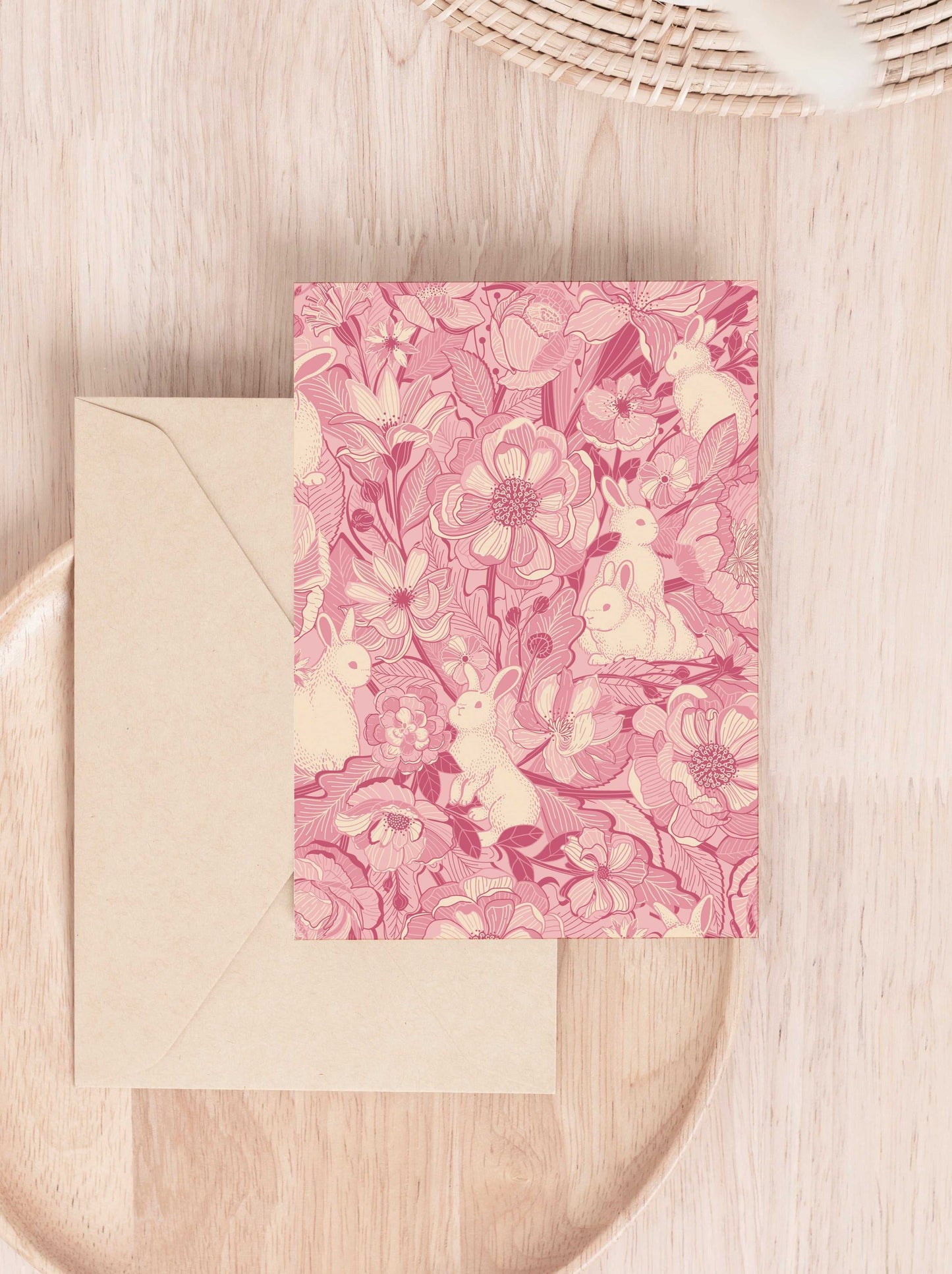 Floral Bunny Greeting Card on a wooden surface with a beige envelope, featuring whimsical rabbit and flower designs.
