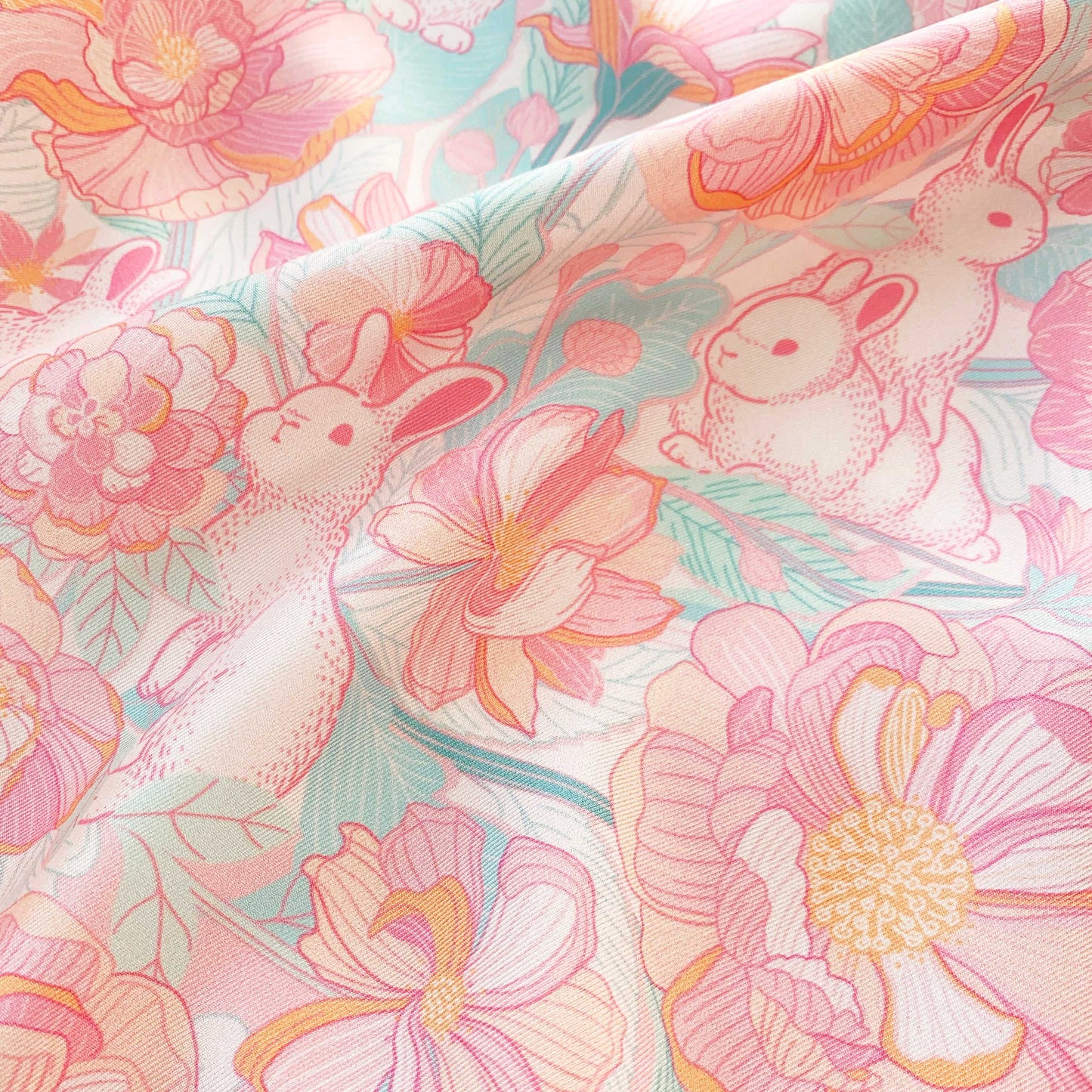 Floral Breeze Silk Twill Scarf featuring illustrated bunnies and vibrant flowers in soft pastel colors.