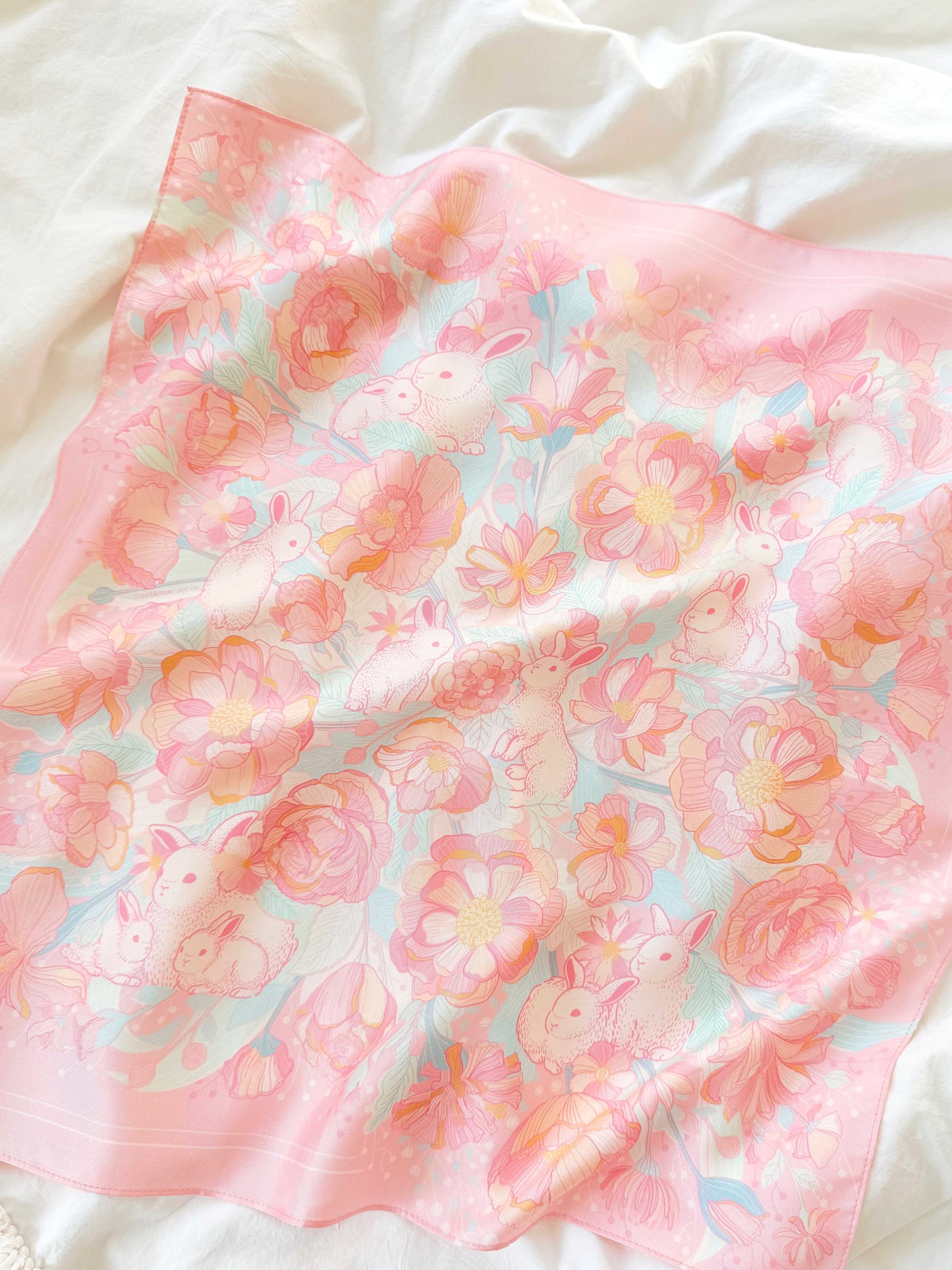 Bunny in the Floral Breeze Silk Twill Scarf featuring pastel bunnies and flowers on a soft pink background.