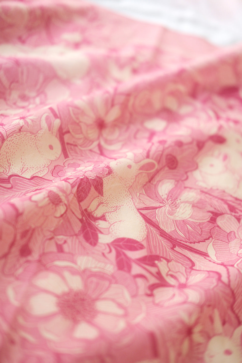 Pink bandana scarf featuring a floral design with rabbits, soft cotton fabric perfect for summer accessories.