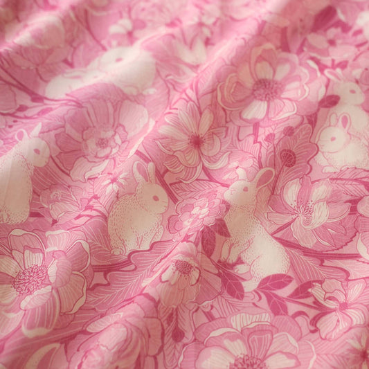 Close-up of pink floral bandana scarf featuring rabbits and flowers, lightweight and perfect for year-round wear.