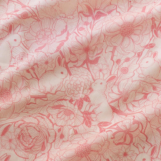 Illustrated pastel pink bandana scarf featuring bunnies and floral designs, perfect for hair, pets, or decor.
