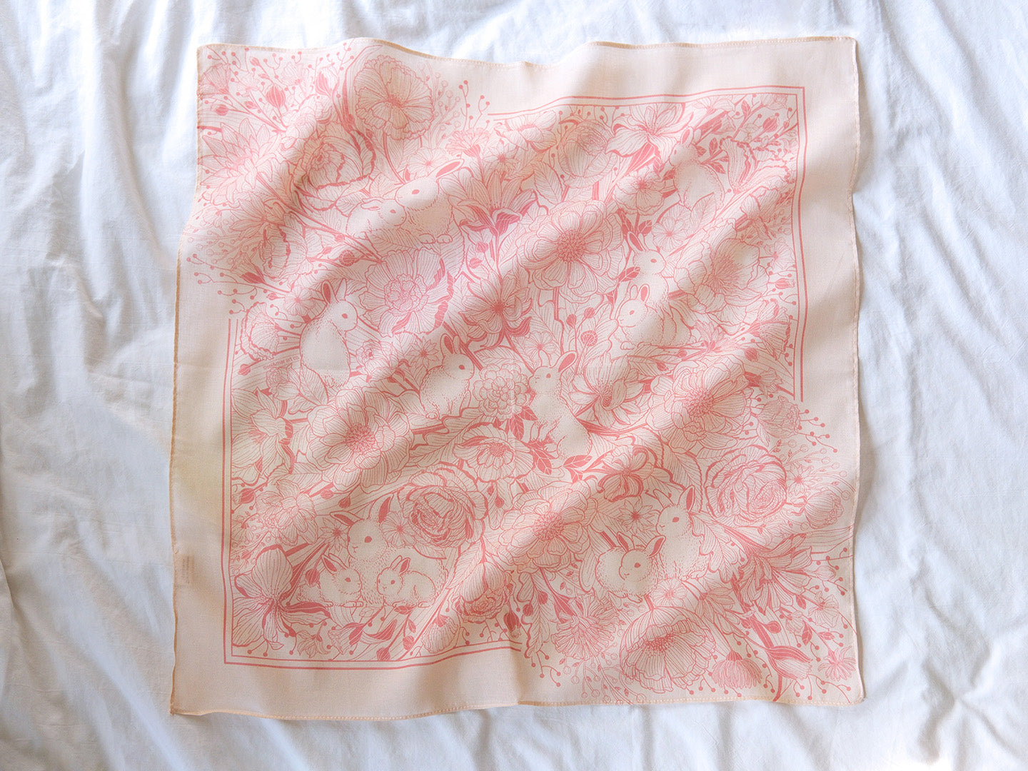 Bunny in the Floral Breeze Bandana Scarf illustration featuring rabbits and flowers in pastel pink.