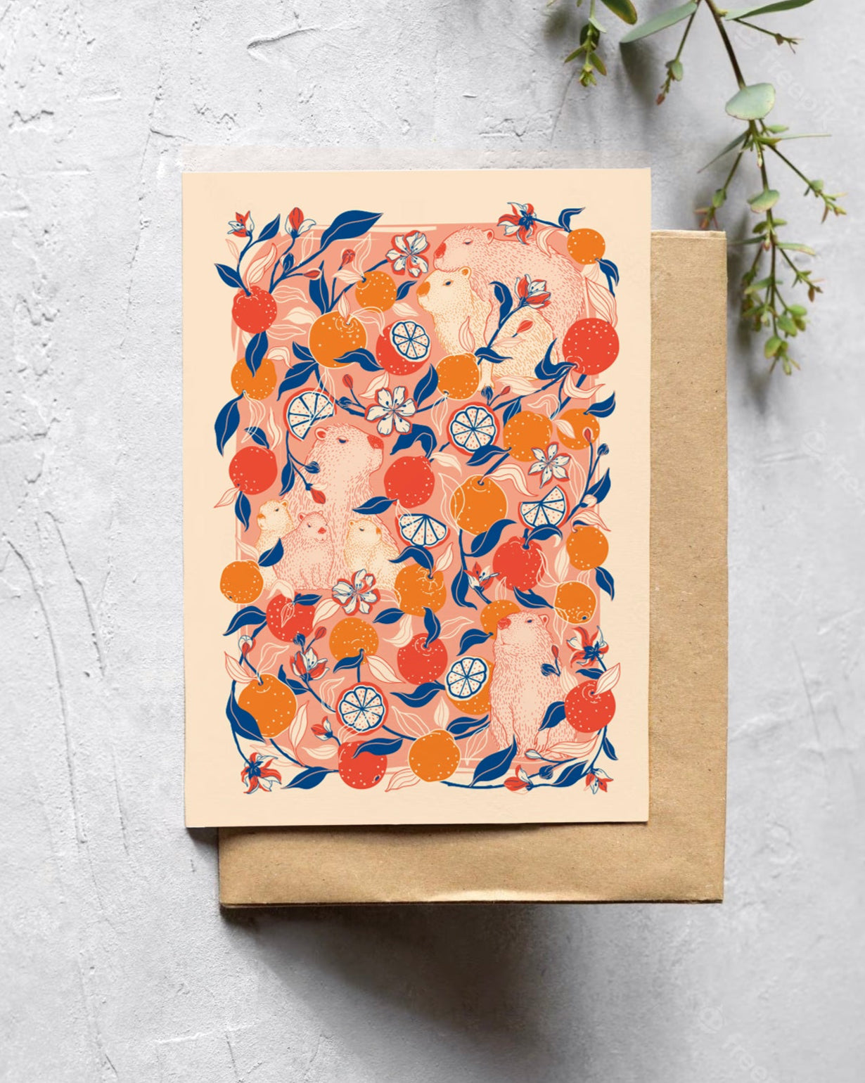 Greeting card with citrus capybara design on a textured surface