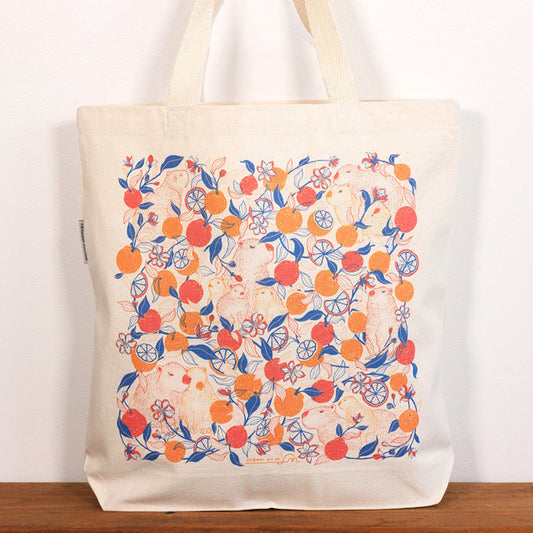 Tote bag with capybara & yuzu orange  pattern on a white background