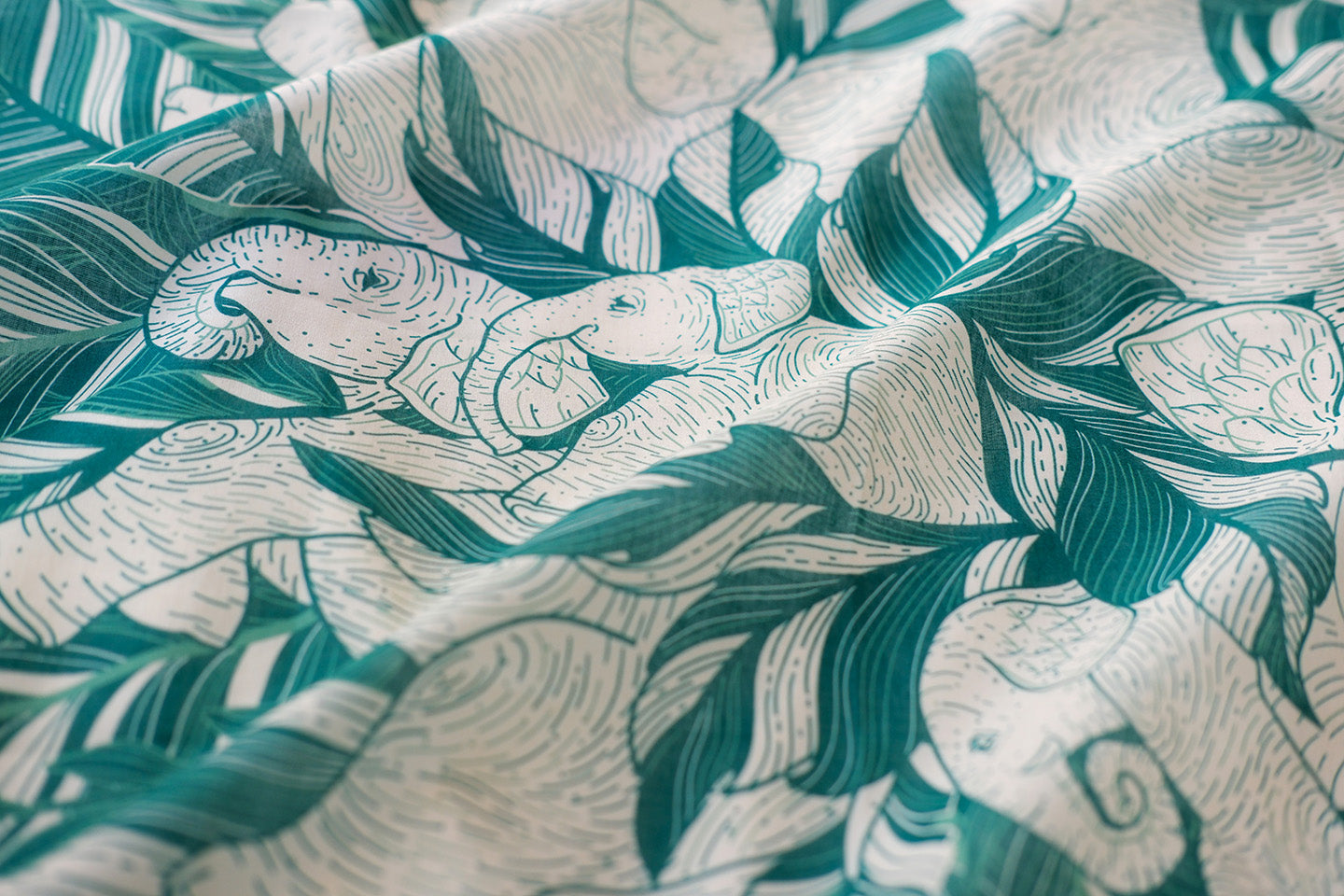 Green 'Siesta' bandana scarf featuring illustrated elephants and jungle leaves, soft cotton fabric.