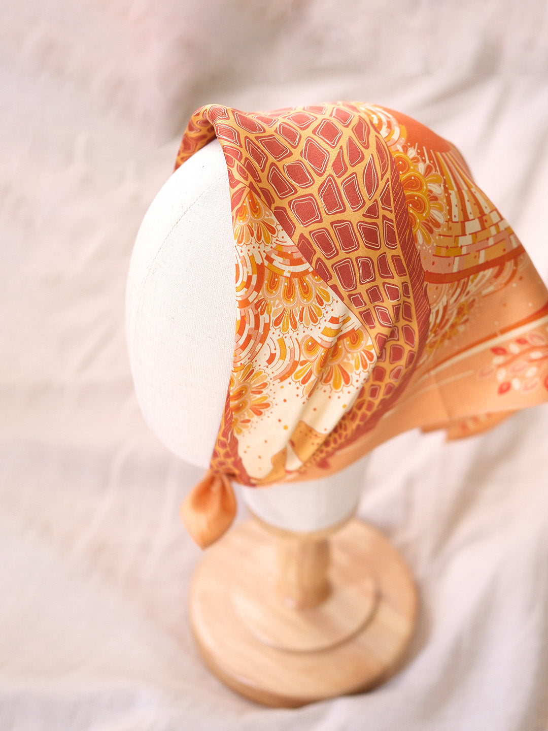 Decorative headscarf on a mannequin head with a soft background