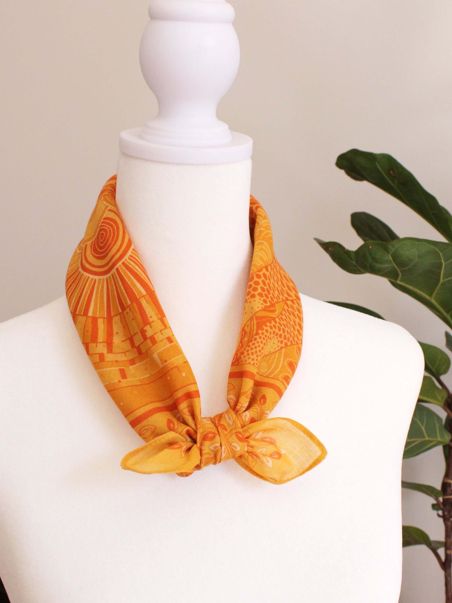 Golden yellow bandana scarf featuring giraffe art, perfect for hair, pets, or fashion accessories.