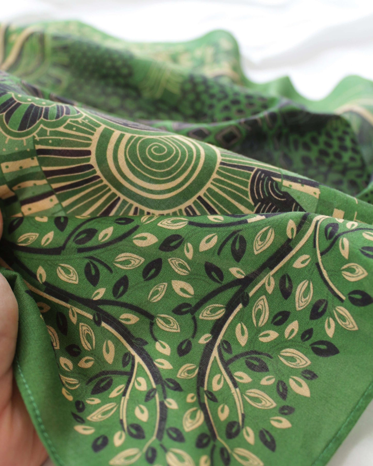 Giraffe family art on olive green cotton bandana scarf with leaf patterns, showcasing vibrant savanna design.