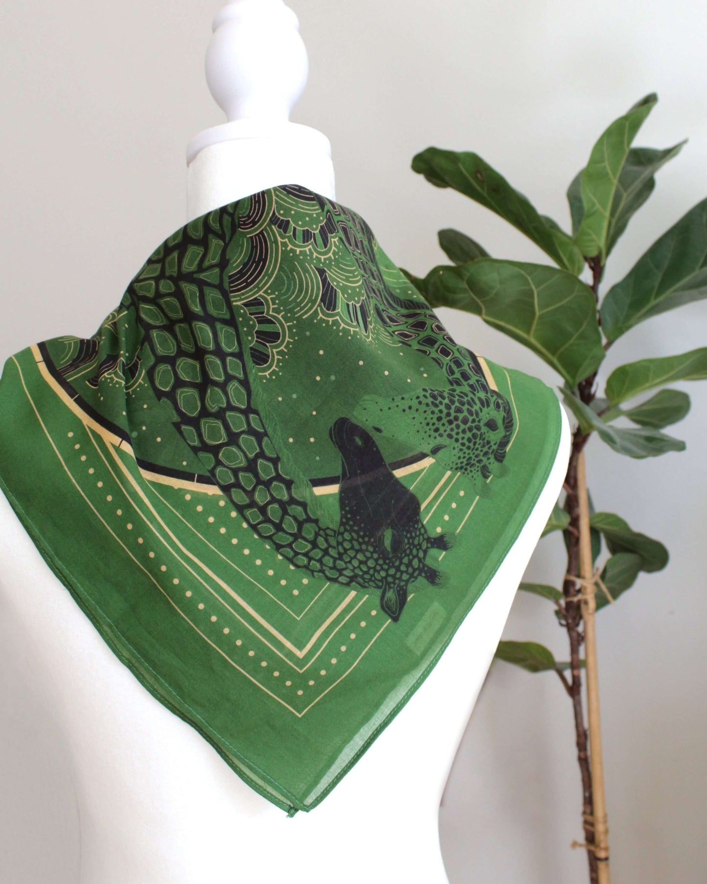Olive green bandana scarf featuring a giraffe family design, perfect as a hair accessory or pet scarf.