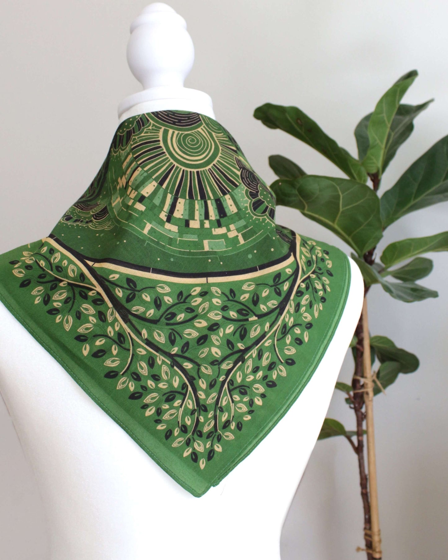 Olive green bandana scarf with artistic pattern, perfect as a hair accessory or pet scarf.
