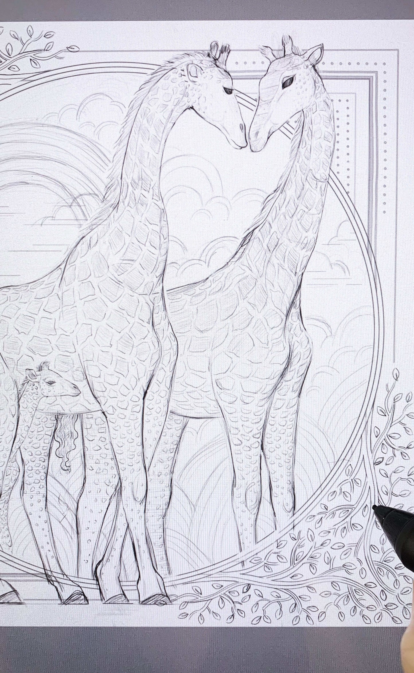 Sketch of two giraffes with intricate patterns and a baby giraffe in a circle surrounded by clouds.