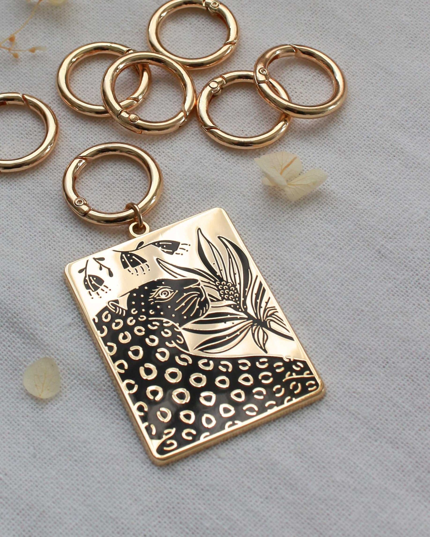 Leopard and flowers enamel keychain with gold-plated finish, featuring a rectangular charm design.