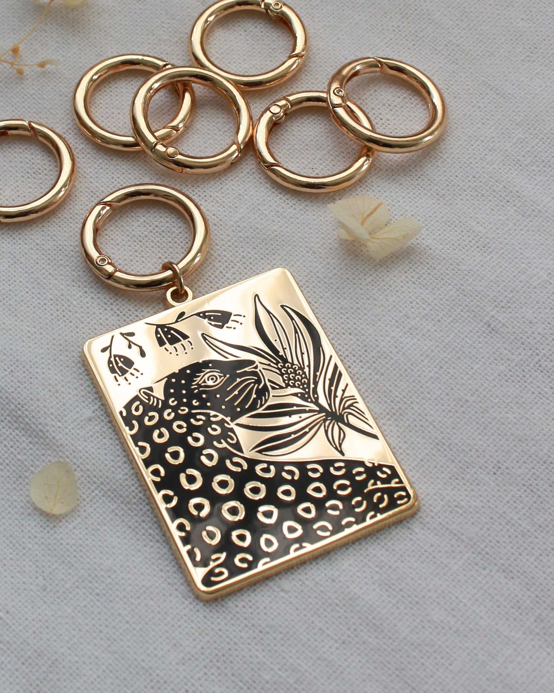 Leopard and flowers enamel keychain with gold-plated finish, featuring a rectangular charm design.