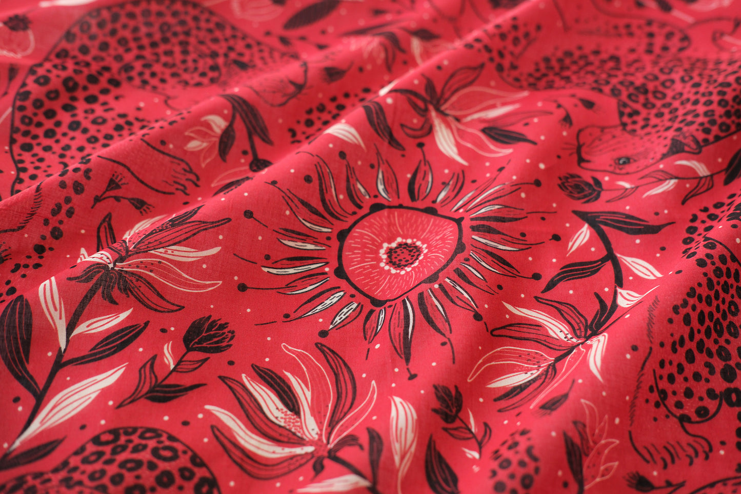 Red fabric with black floral pattern