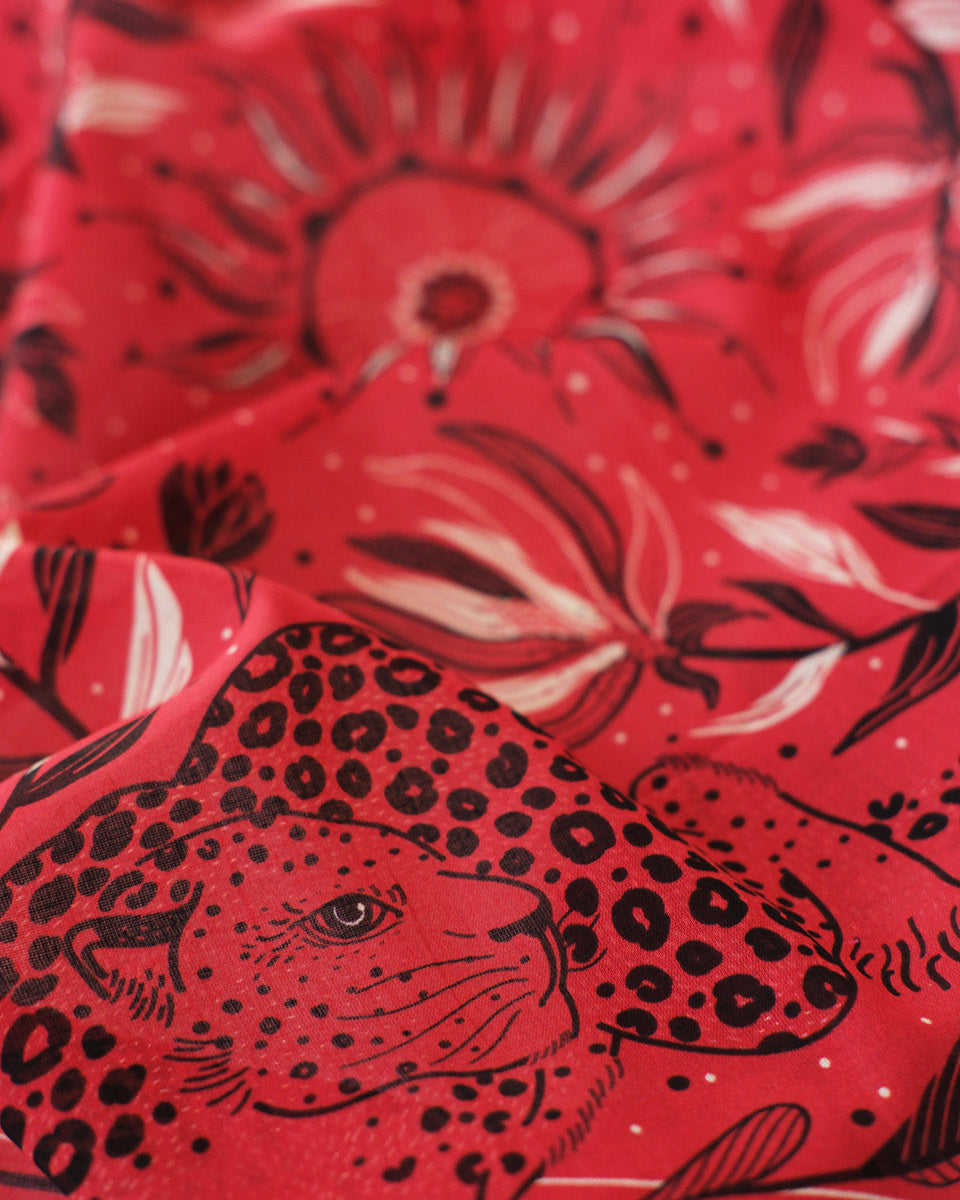 Red fabric with black leopard and floral pattern