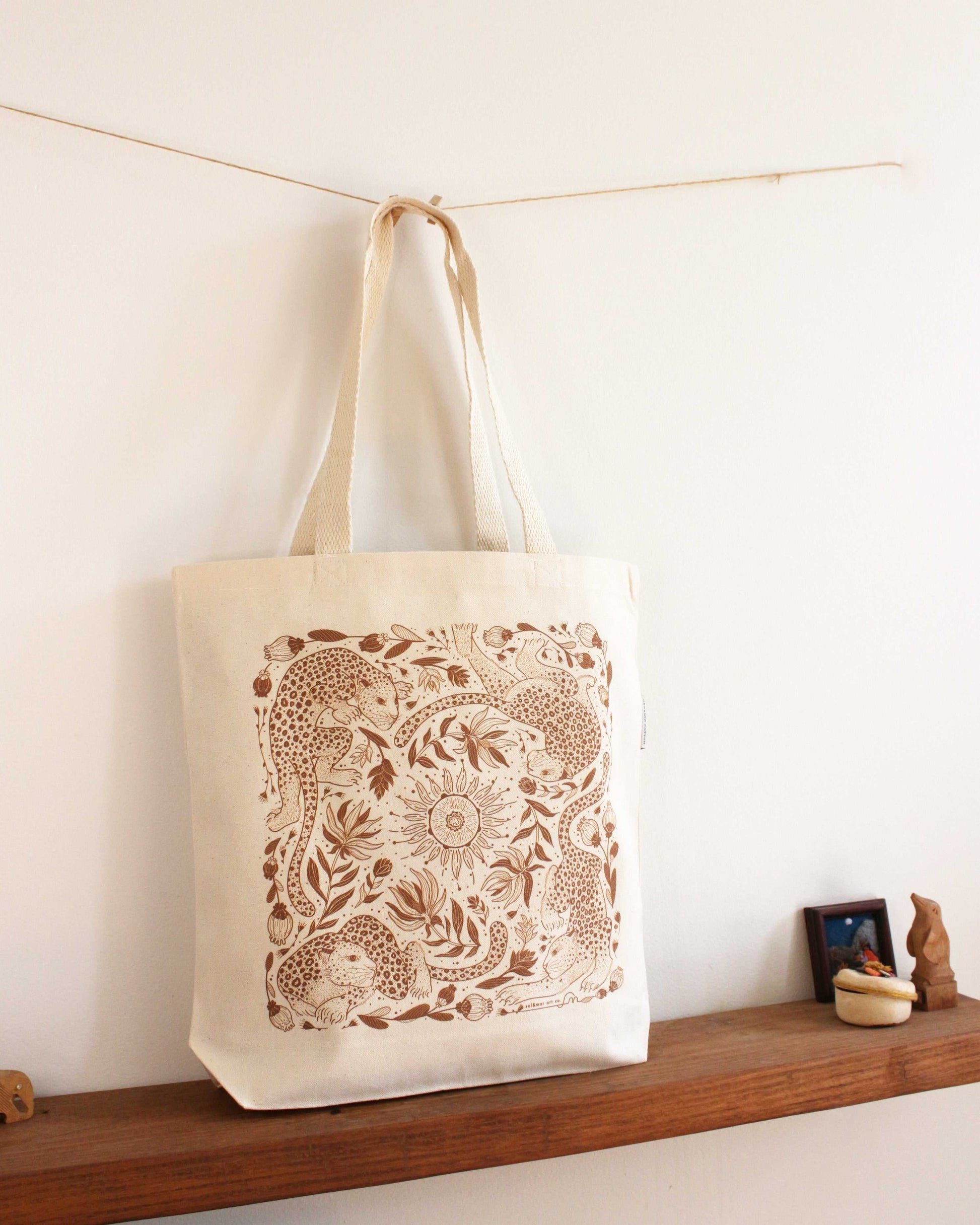 Leopard and the Sun canvas tote bag featuring intricate line art design on organic cotton for everyday use.
