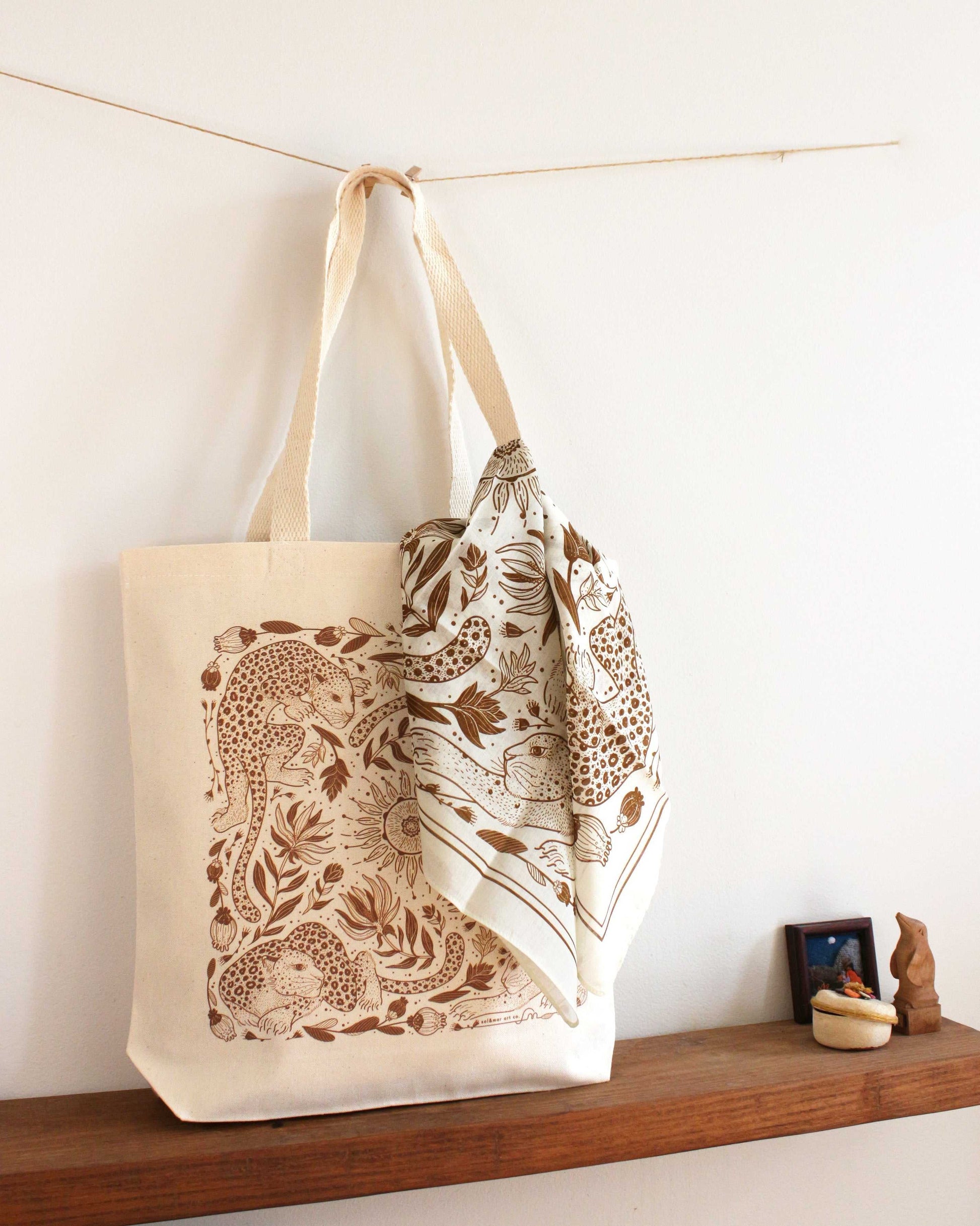 Leopard and the Sun canvas tote bag with floral design, adorned with a scarf, perfect for everyday use.