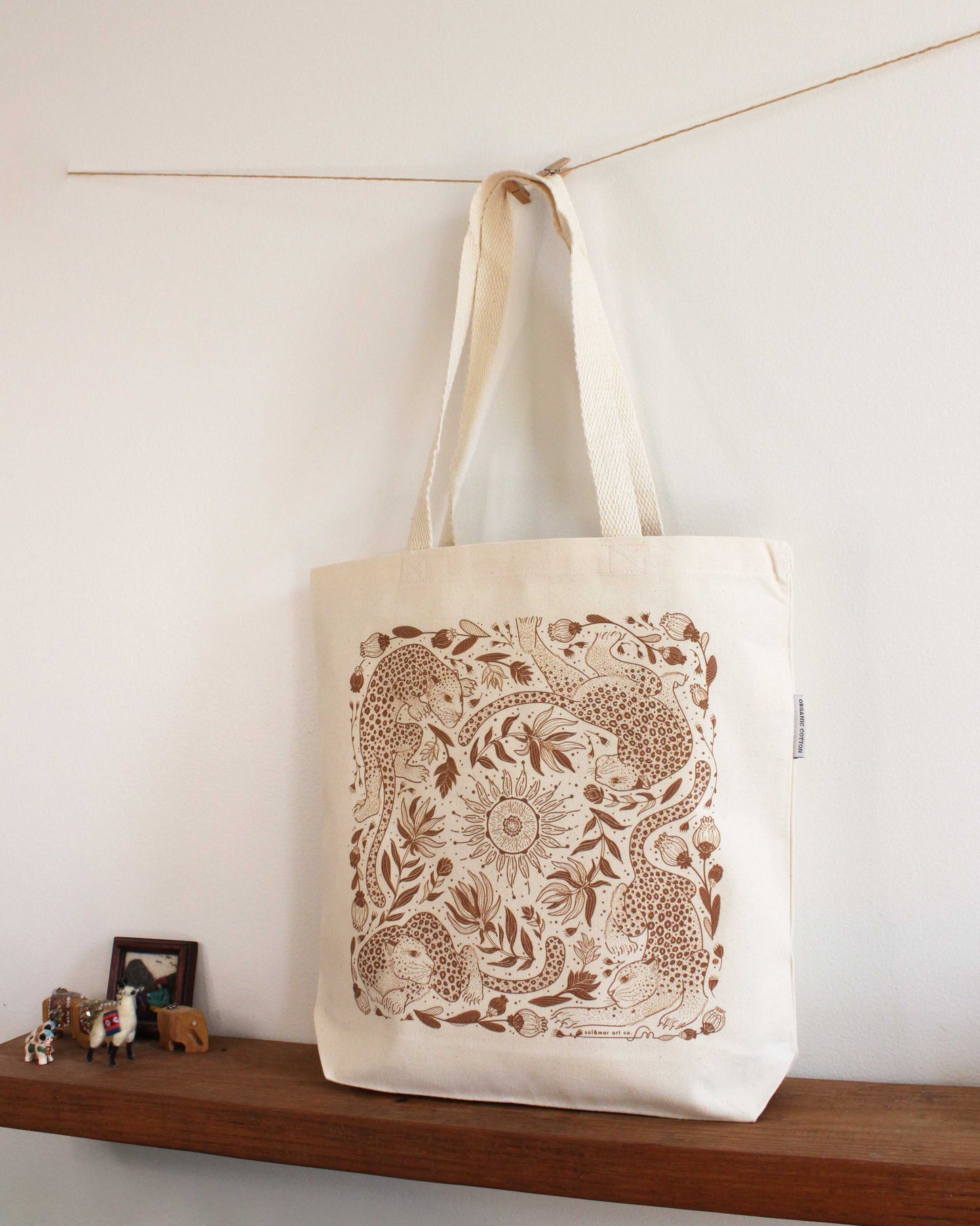 Leopard and the Sun canvas tote bag featuring elegant line art, perfect for everyday use and eco-friendly options.