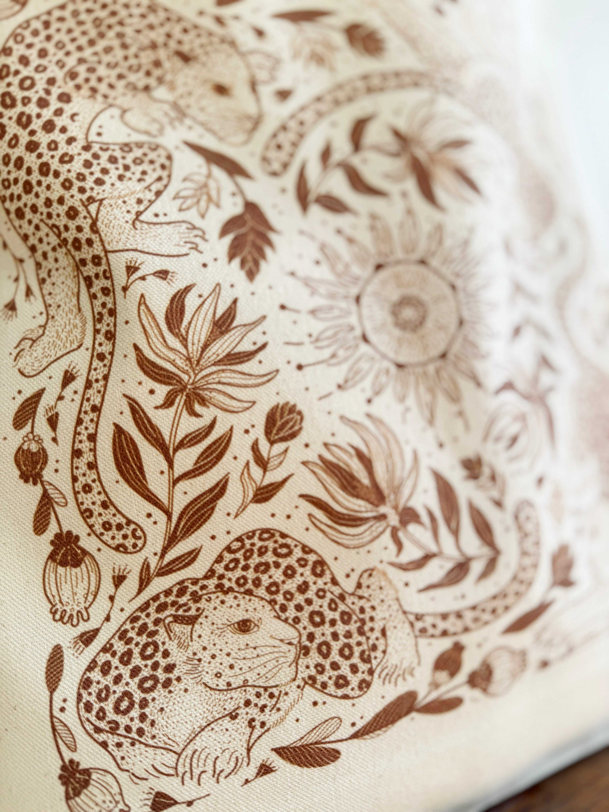 Close-up of Leopard and the Sun line art on organic cotton canvas tote bag, featuring intricate floral and leopard designs.