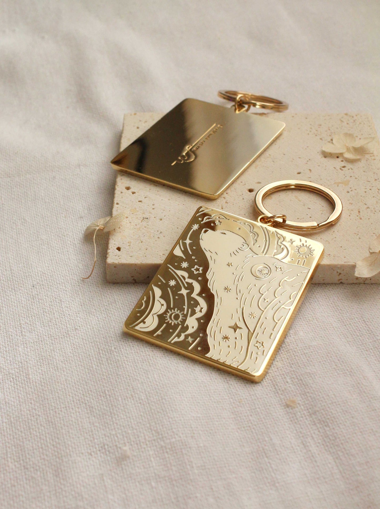 Gold-plated enamel keychain featuring a detailed polar bear design and smooth rectangular shape.