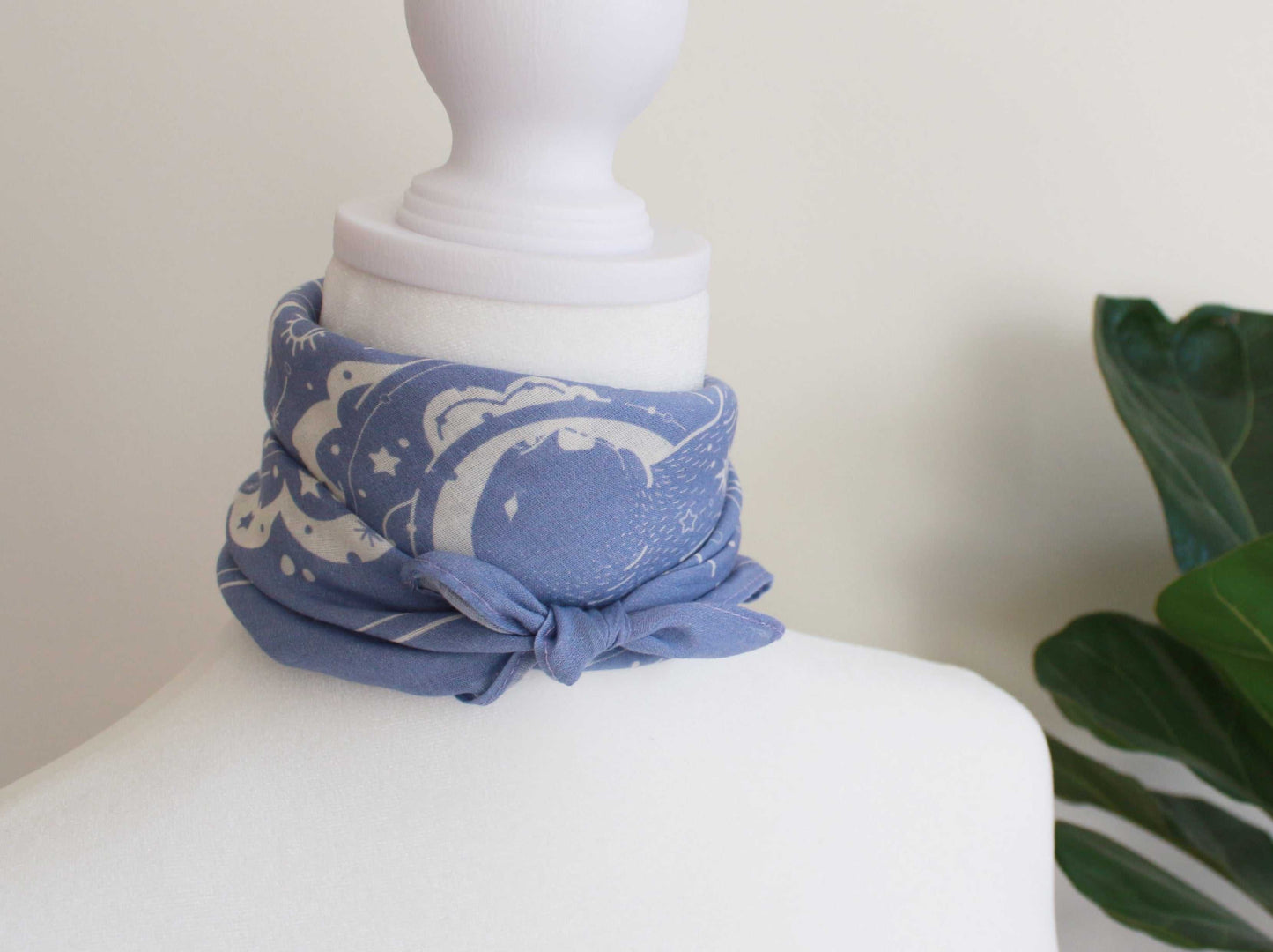 Light lavender bandana scarf with polar bear and northern sky art styled on a mannequin neck.