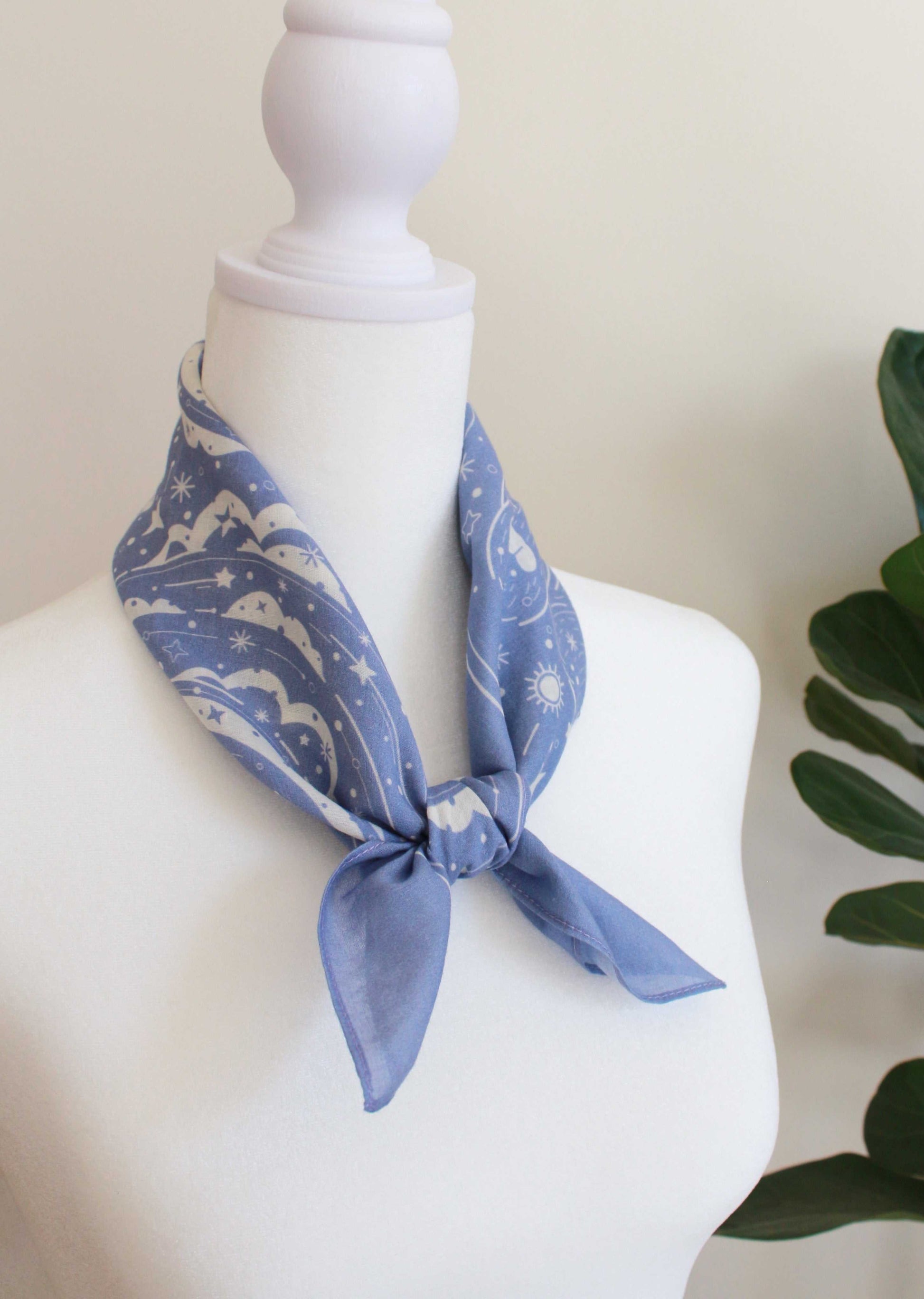 Lavender bandana scarf with polar bear and northern sky design, styled around a mannequin neck.