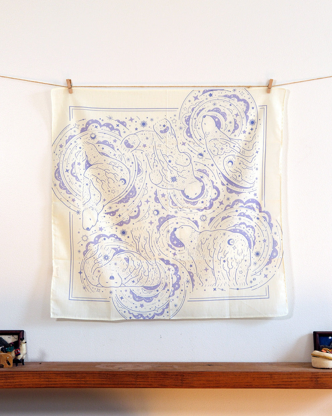 Polar Bear and Northern Sky design bandana scarf displayed on a wall, showcasing soft cotton art in off-white color.