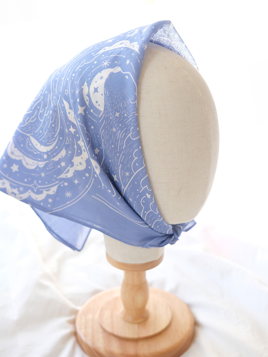 Lavender Polar Bear and Northern Sky bandana scarf displayed on a mannequin head, showcasing its artistic design.
