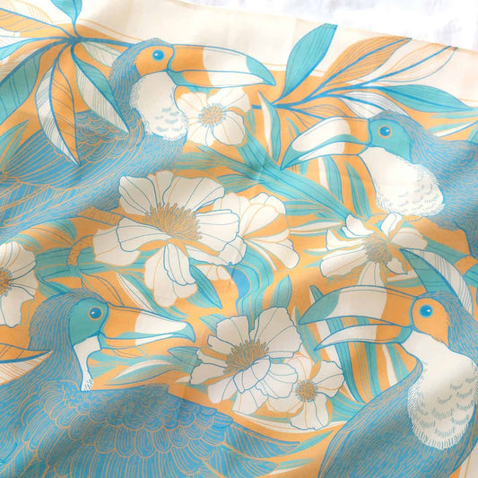 Vibrant yellow bandana scarf featuring toucans and floral jungle design, perfect for accessories or décor.