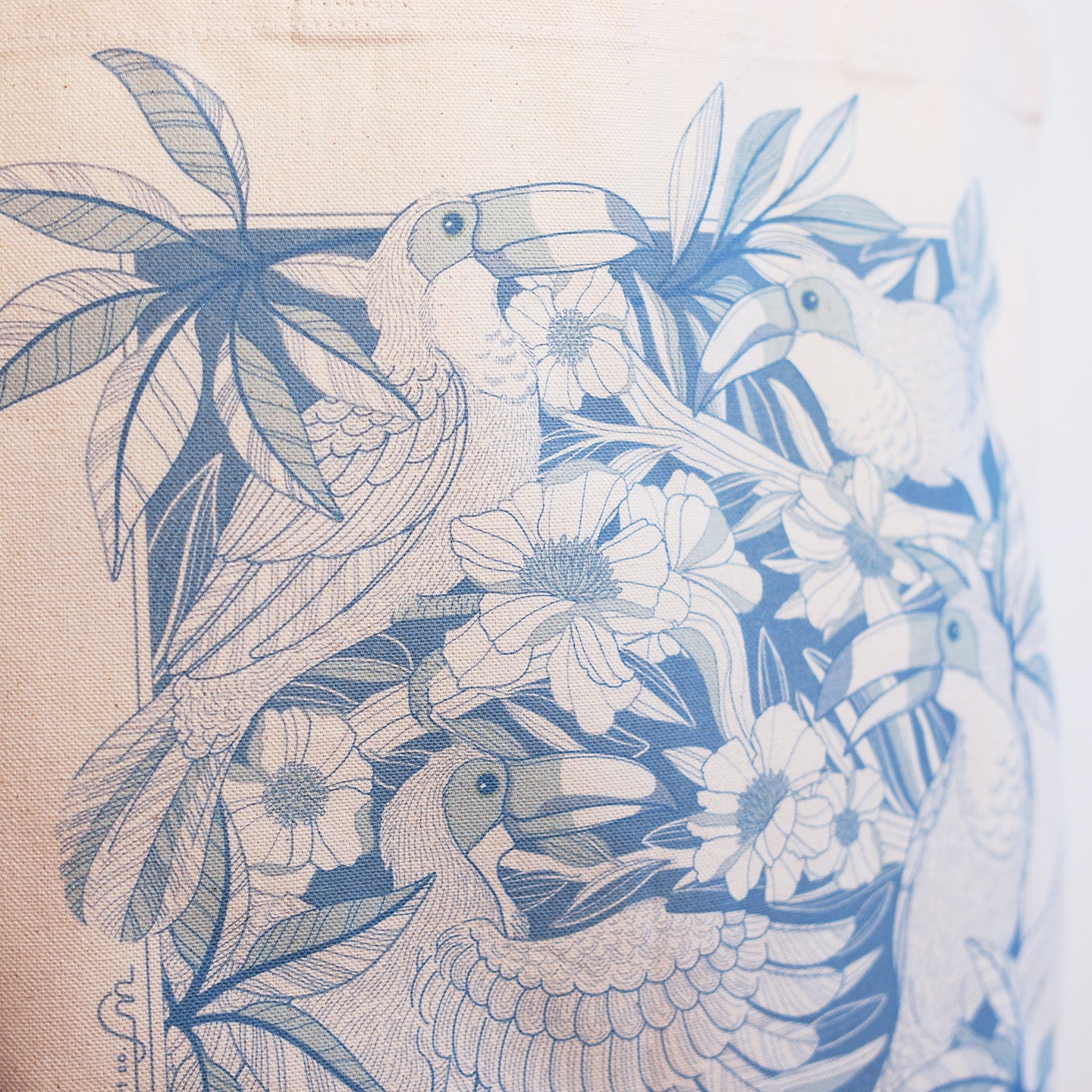 Canvas Tote bag with blue Toucan and floral pattern on beige background
