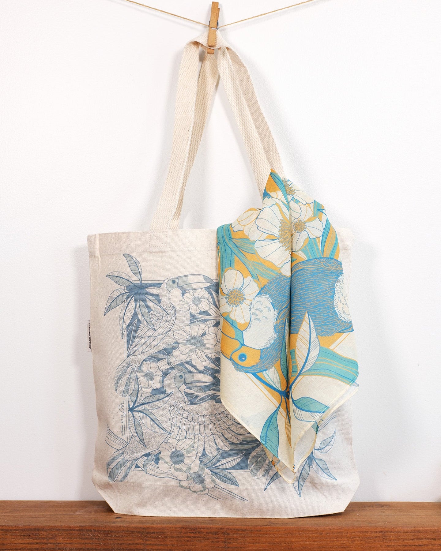 Tote bag with Toucan & floral design and matching scarf on a wooden surface