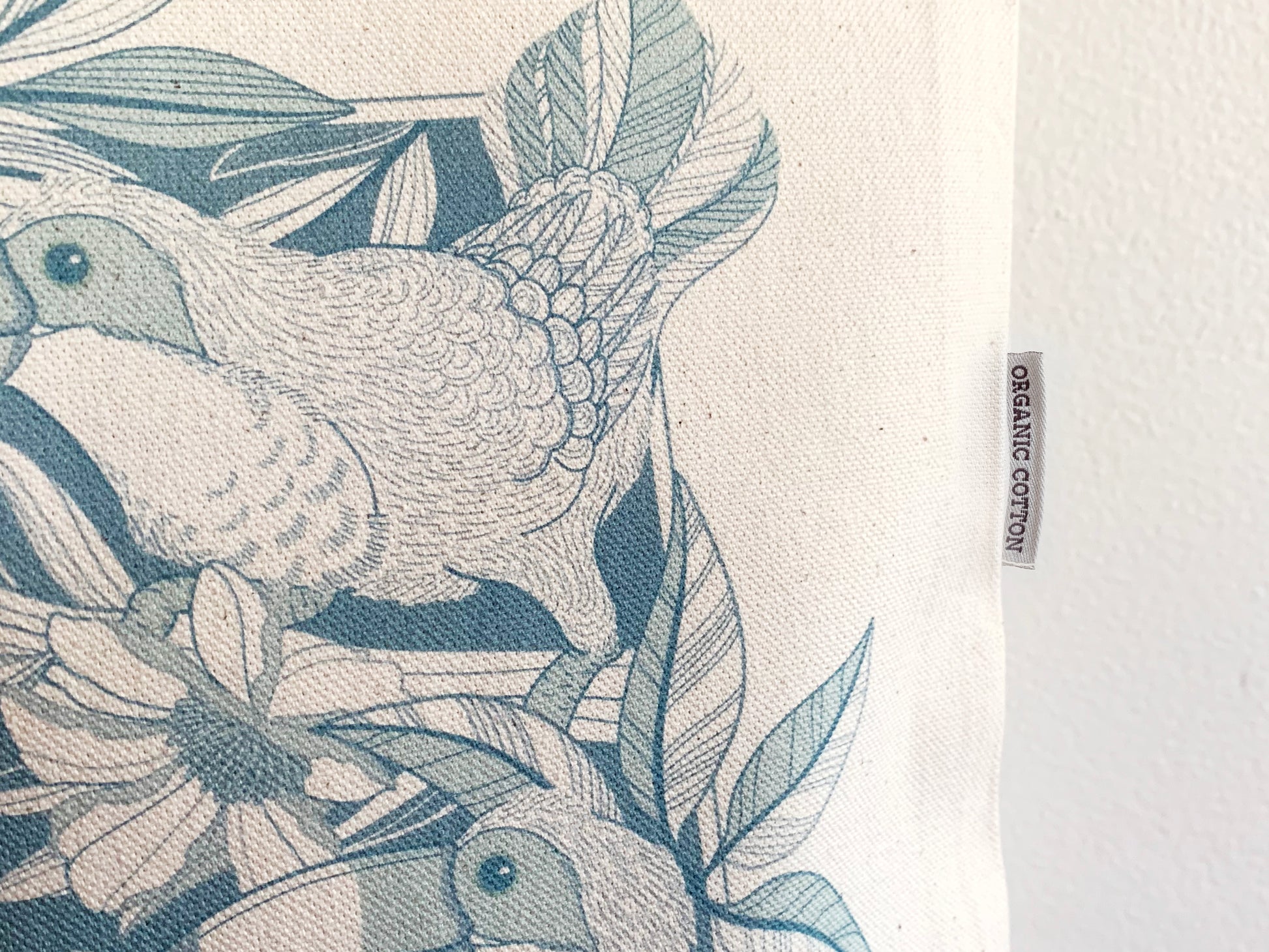 Textile with bird and leaf pattern and organic cotton label