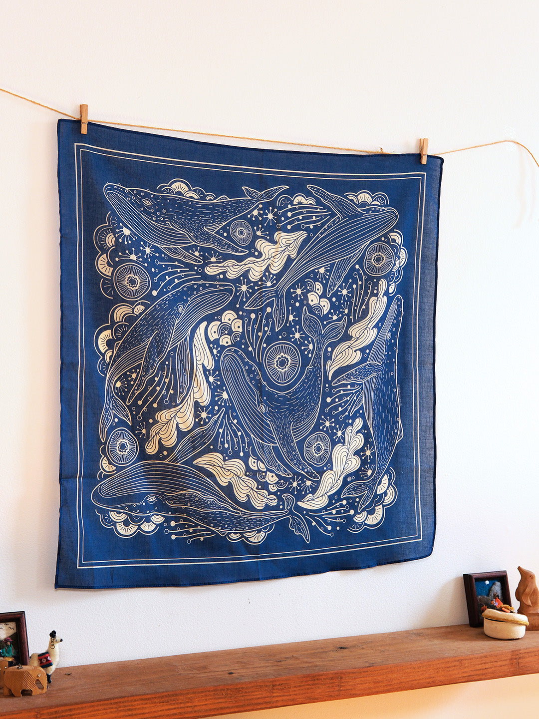 Navy bandana scarf featuring humpback whales and ocean art, perfect for accessories and decor.