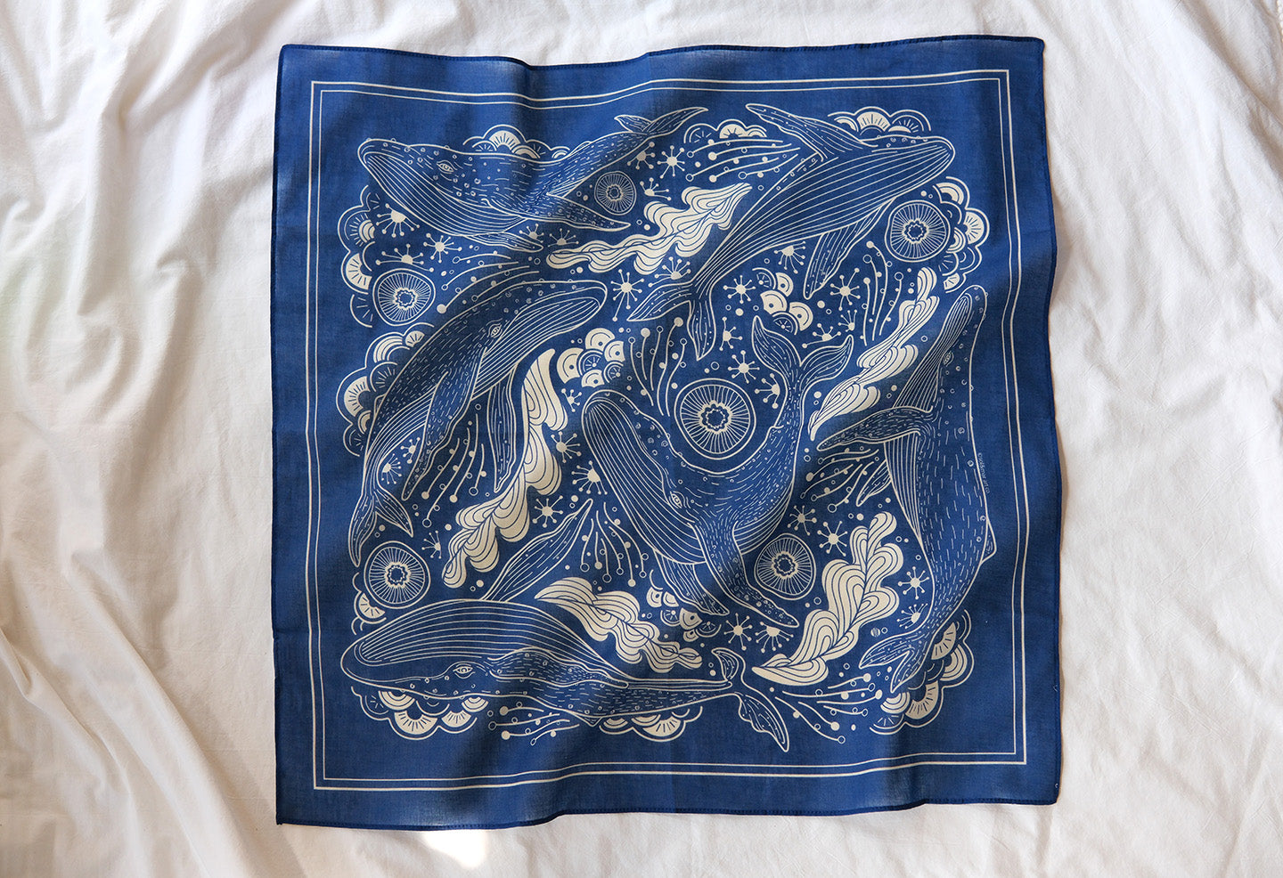 Navy bandana scarf featuring Humpback whales and ocean art design, soft 100% cotton accessory.