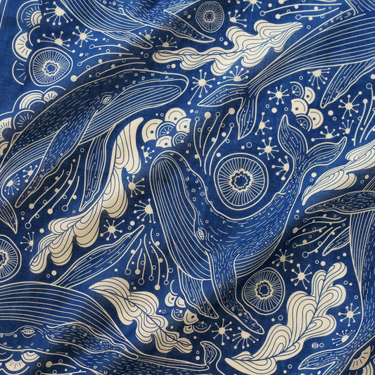 Navy bandana scarf featuring intricate illustrations of humpback whales and ocean waves, perfect for accessories and decor.