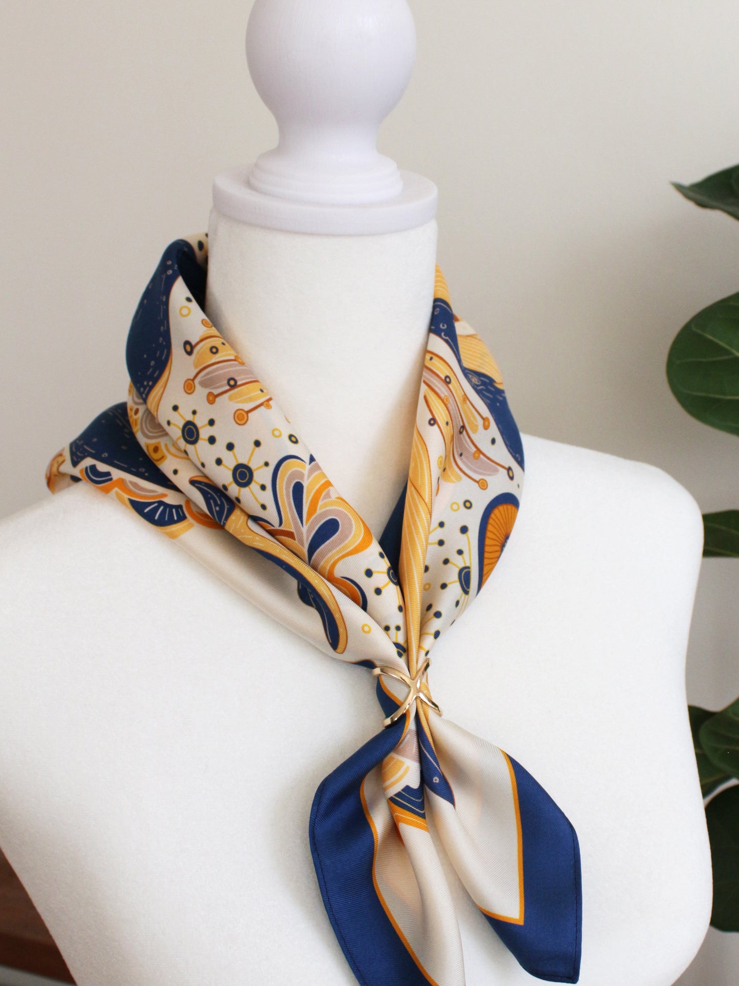 Whale and the Ocean Silk Twill Scarf elegantly tied around a mannequin neck, showcasing its artistic design.