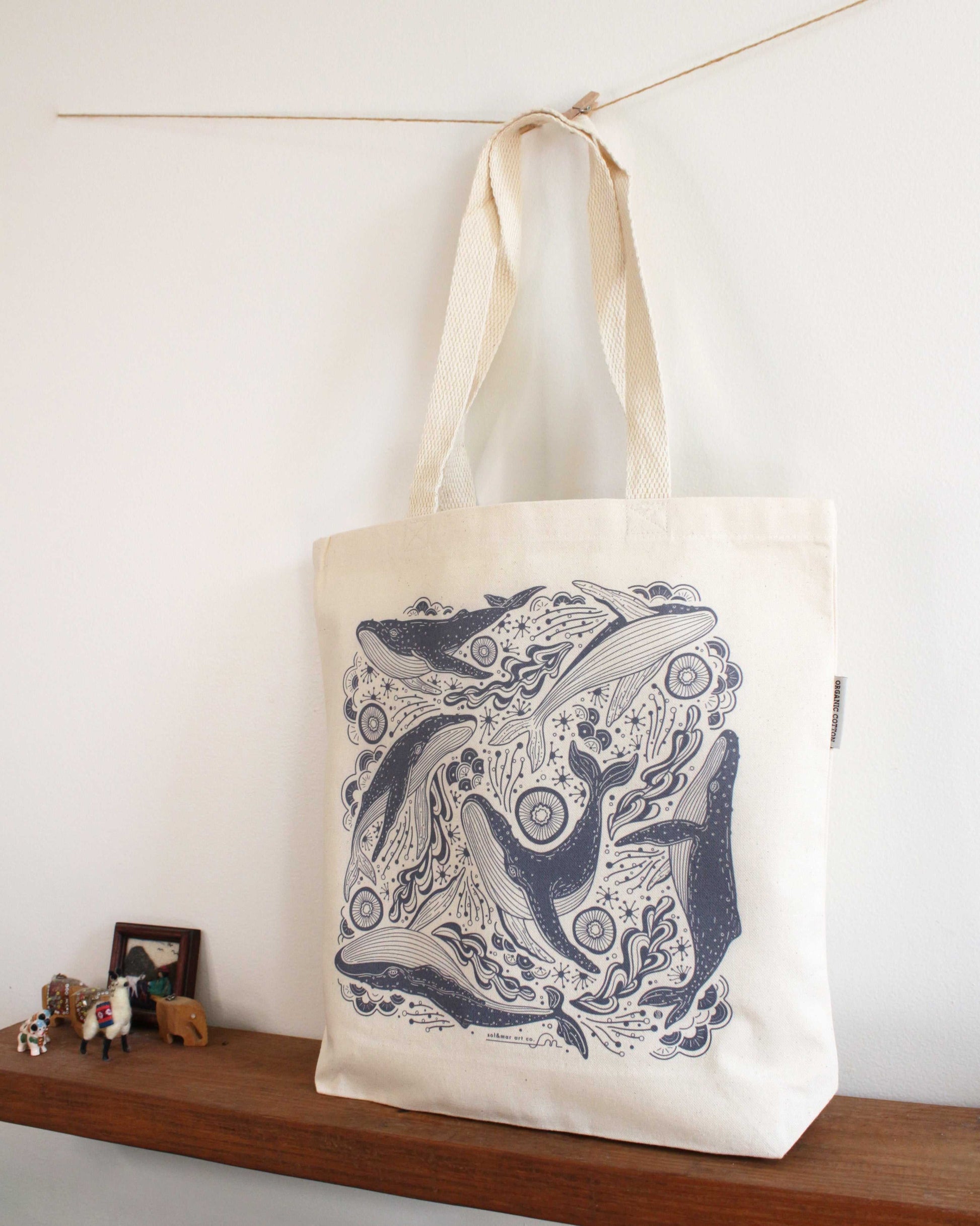 Canvas tote bag featuring intricate whale line art, perfect for daily use and eco-friendly shopping.