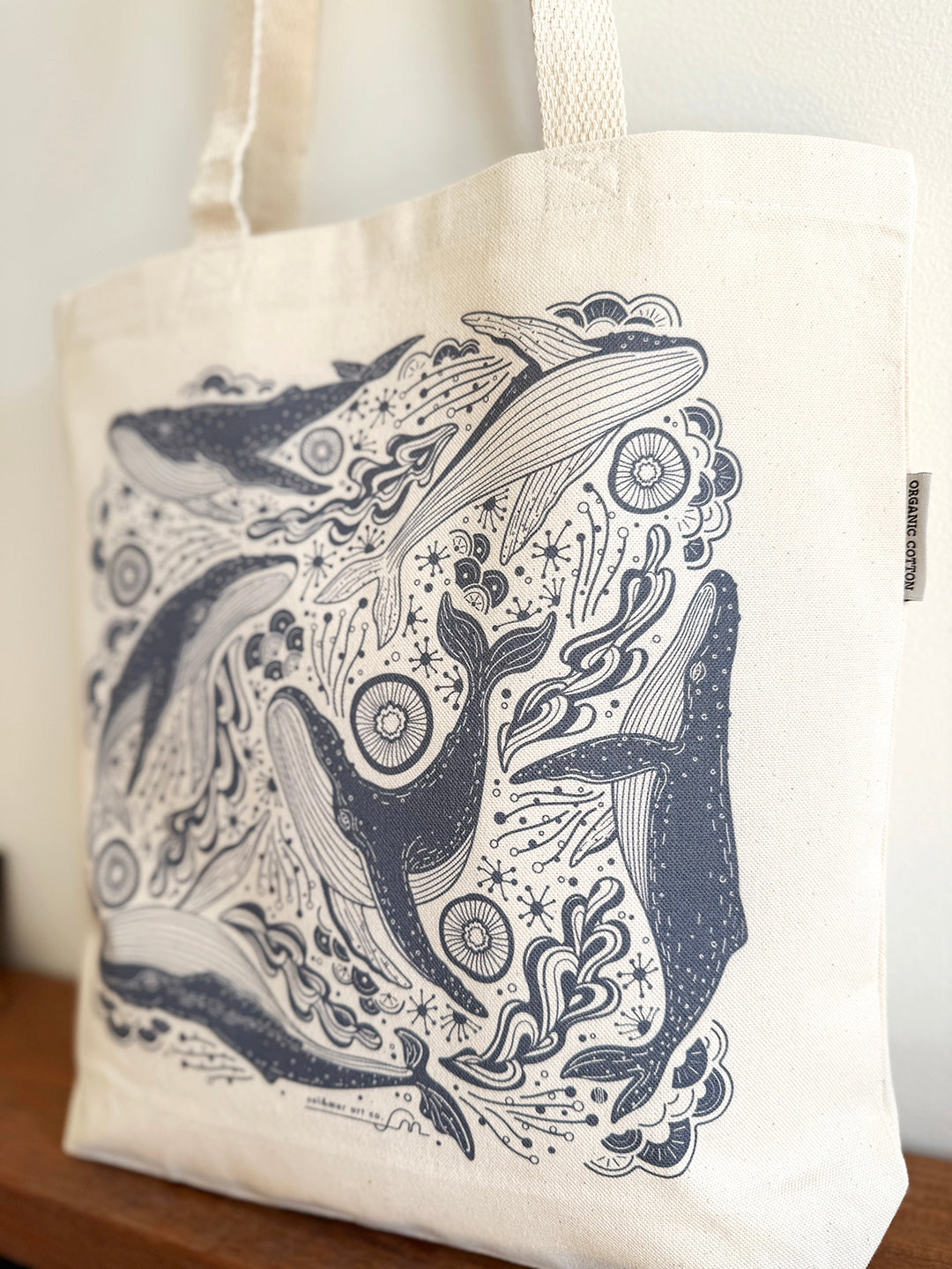 Whale and Ocean canvas tote bag featuring intricate humpback whale line art on organic cotton.