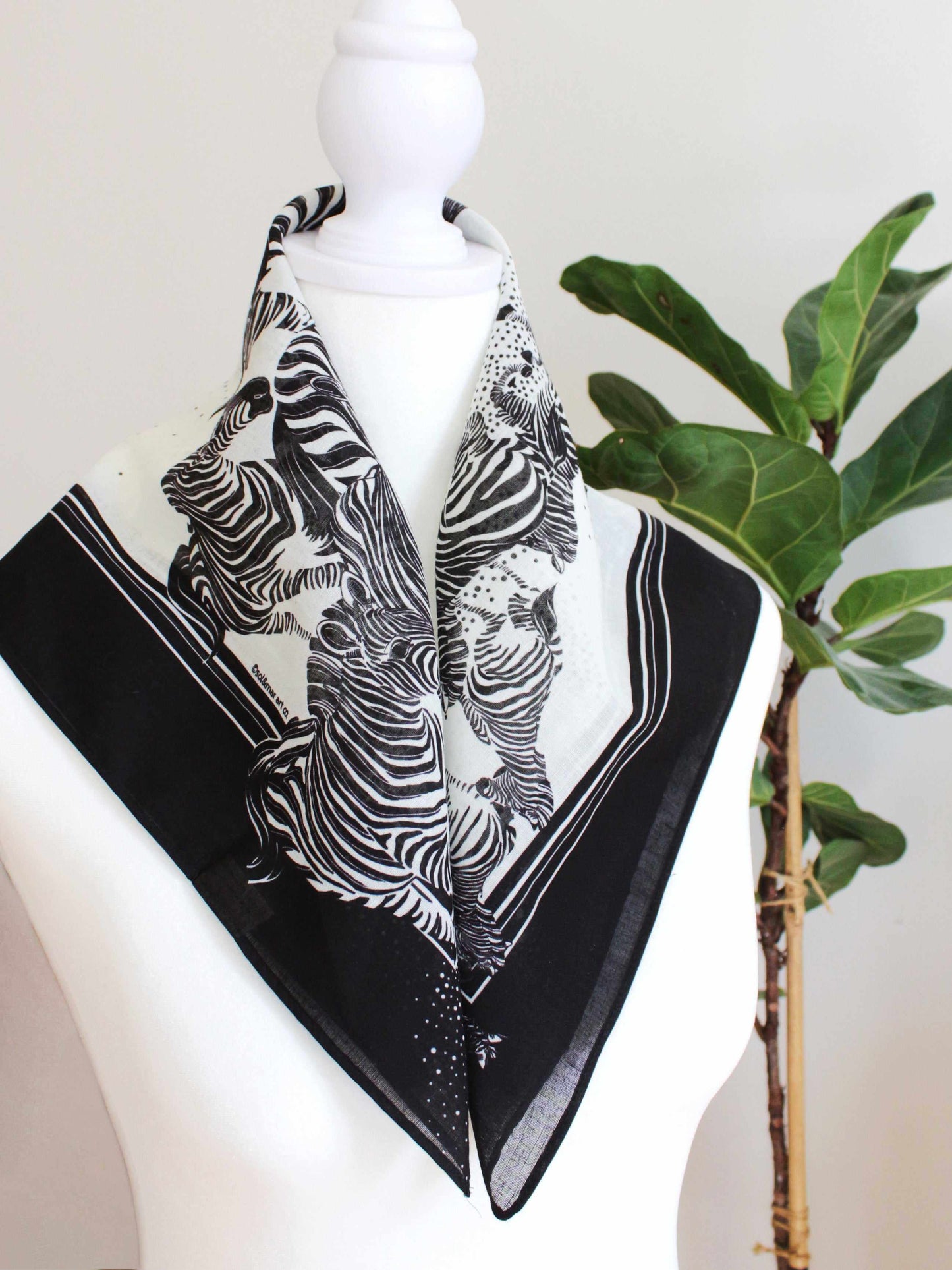 Black and white Zebra bandana scarf artfully displayed on a mannequin, showcasing its lightweight design and versatility.