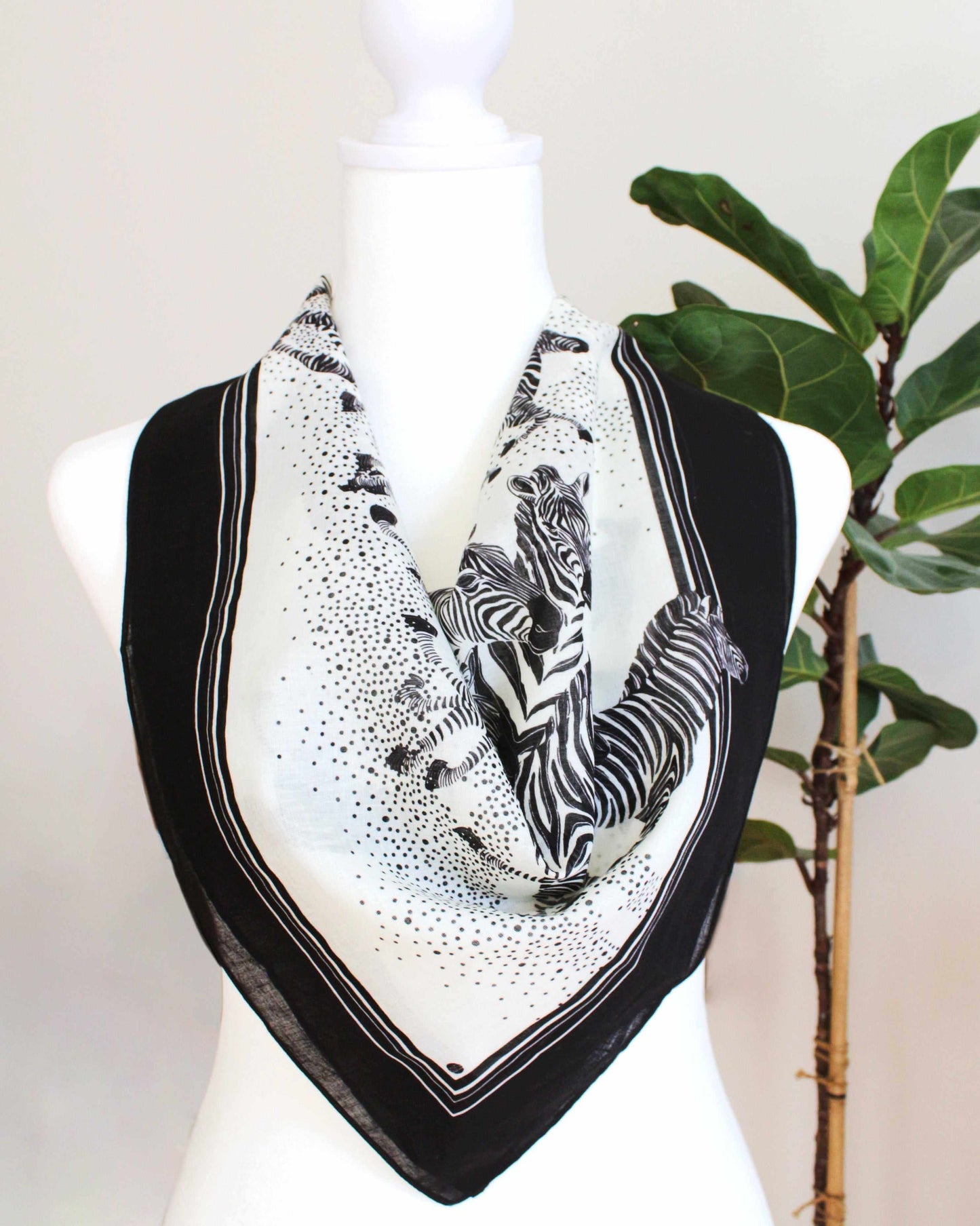 Black and white zebra bandana scarf on mannequin, perfect for hair or bag accessories, soft and lightweight.