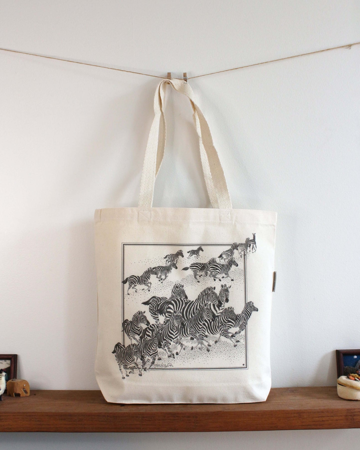 Zebra, "New Beginning" canvas tote bag featuring a herd of zebras in motion, perfect for everyday use.