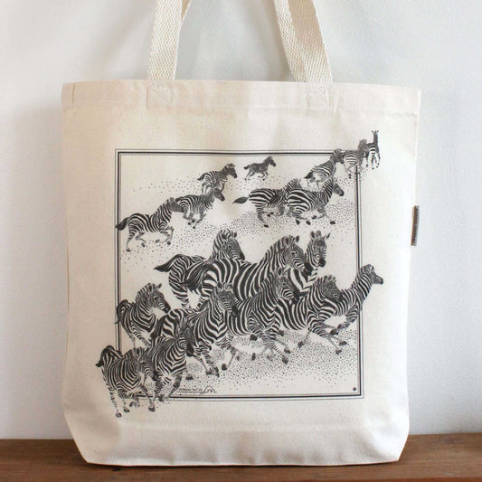 Zebra 'New Beginning' canvas tote bag featuring a stunning herd of zebras in motion, ideal for everyday use.
