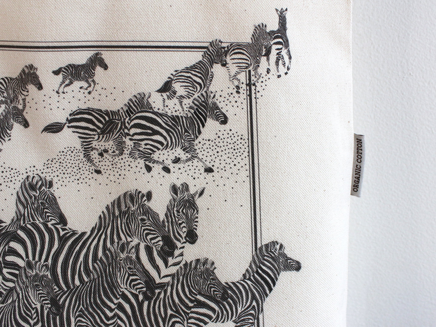 Herd of zebras illustrated on an organic cotton canvas tote bag, perfect for everyday use and stylish outings.